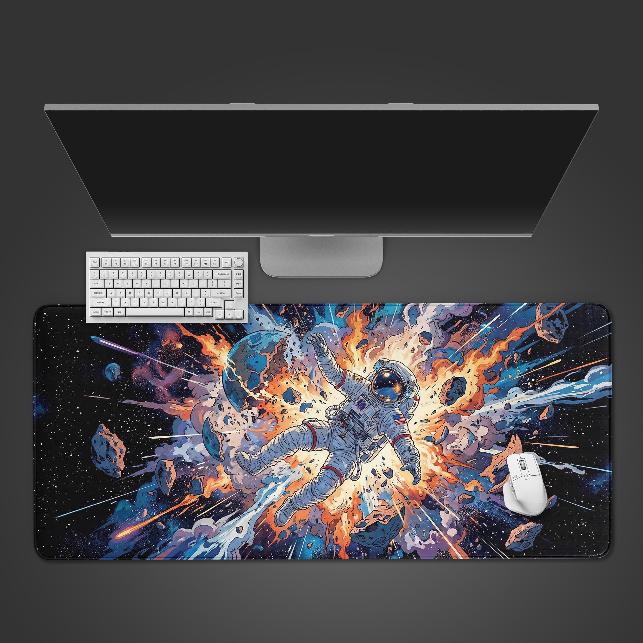 Top-down view of the Space Explosion gaming desk mat with a white keyboard and mouse, showcasing the vibrant astronaut and planet explosion artwork on a dark gray background. - Epic Design Pads & Mousepads