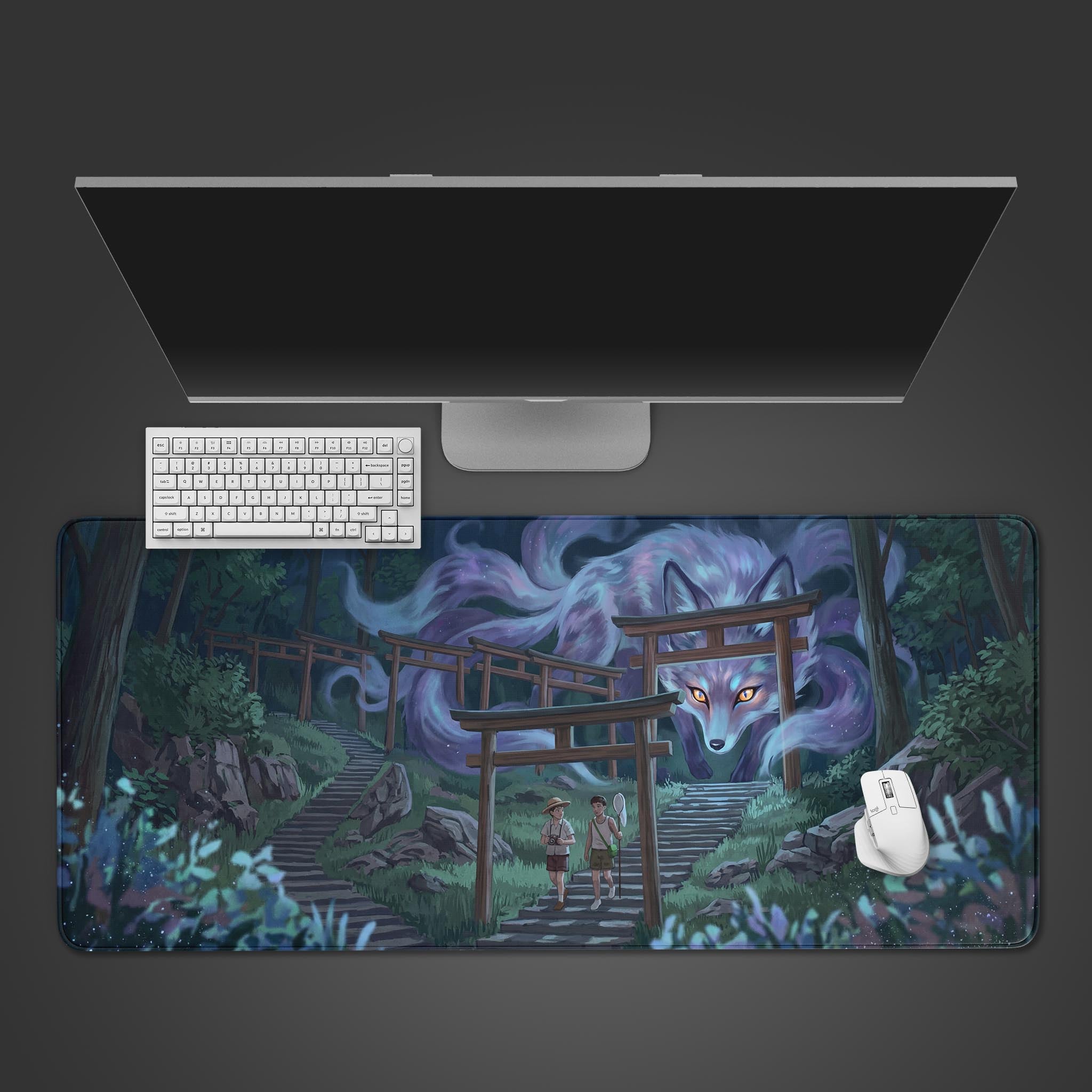 Top-down view of the Spectral Guardian gaming desk mat, featuring a giant Kitsune fox, placed under a modern monitor, keyboard, and white mouse on a dark surface. - Epic Design Pads & Mousepads