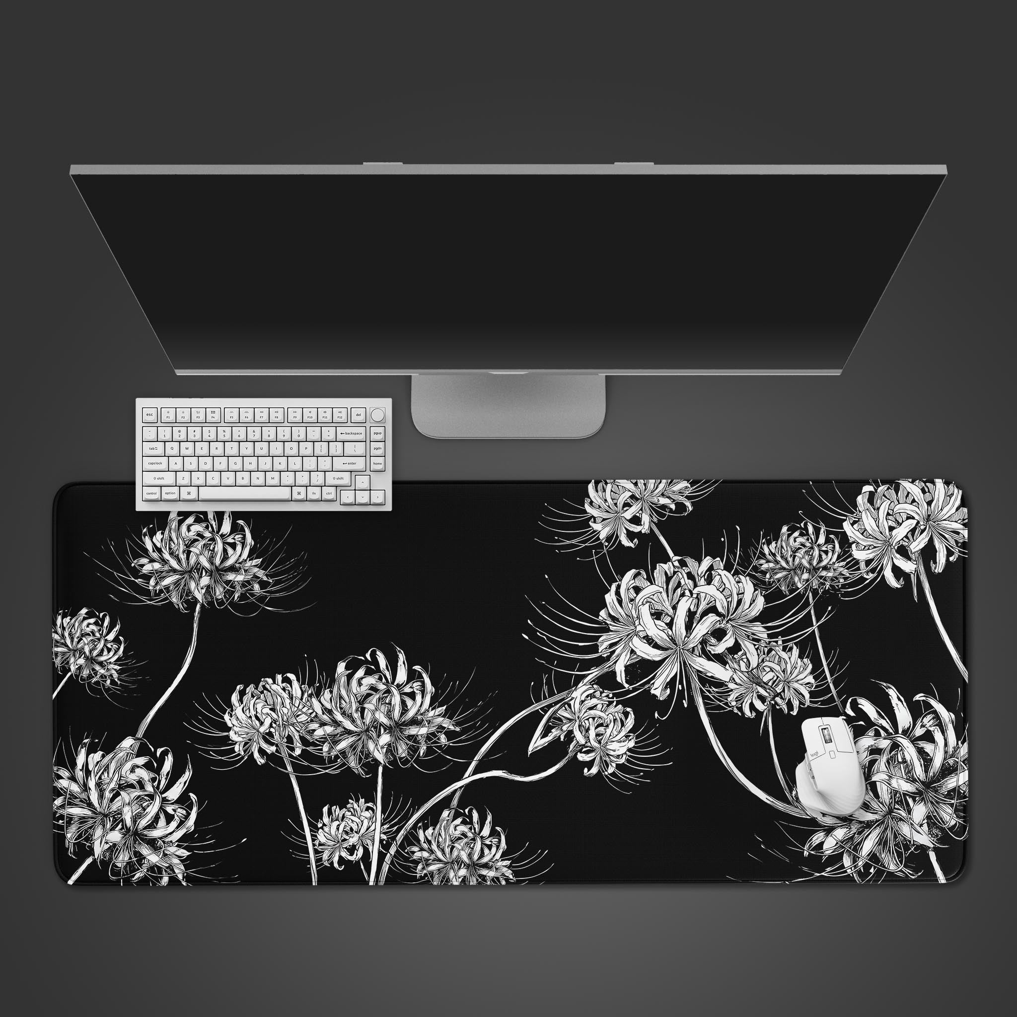White spider lily floral illustration on a black desk mat