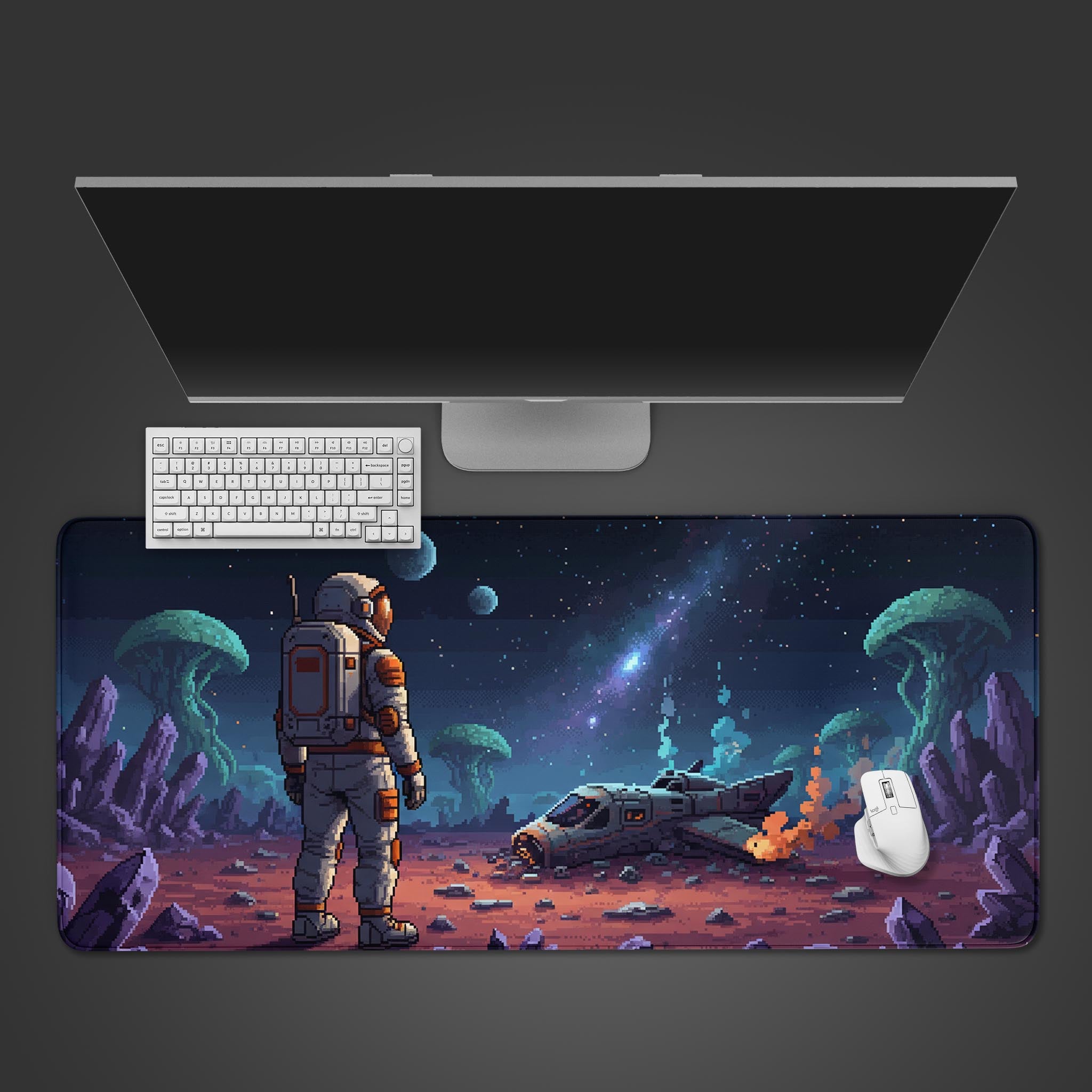 Stranded Explorer pixel art desk mat with an 8-bit astronaut and crashed ship design, shown from a top-down view with a keyboard and mouse. - Epic Design Pads