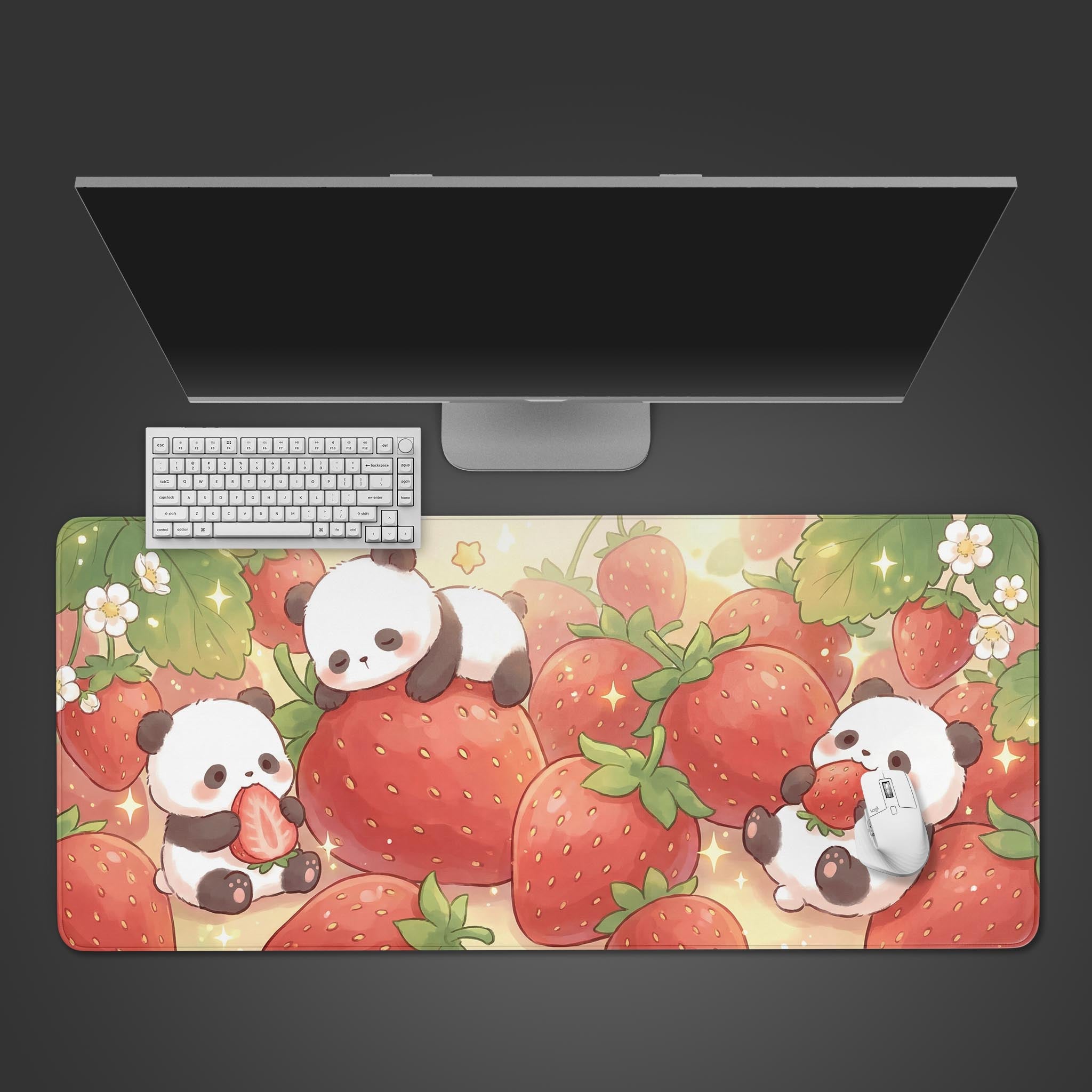 Top-down view of the Strawberry Dreamland gaming desk mat featuring cute pandas among giant strawberries, shown with a white keyboard and monitor on a dark surface. - Epic Design Pads & Mousepads