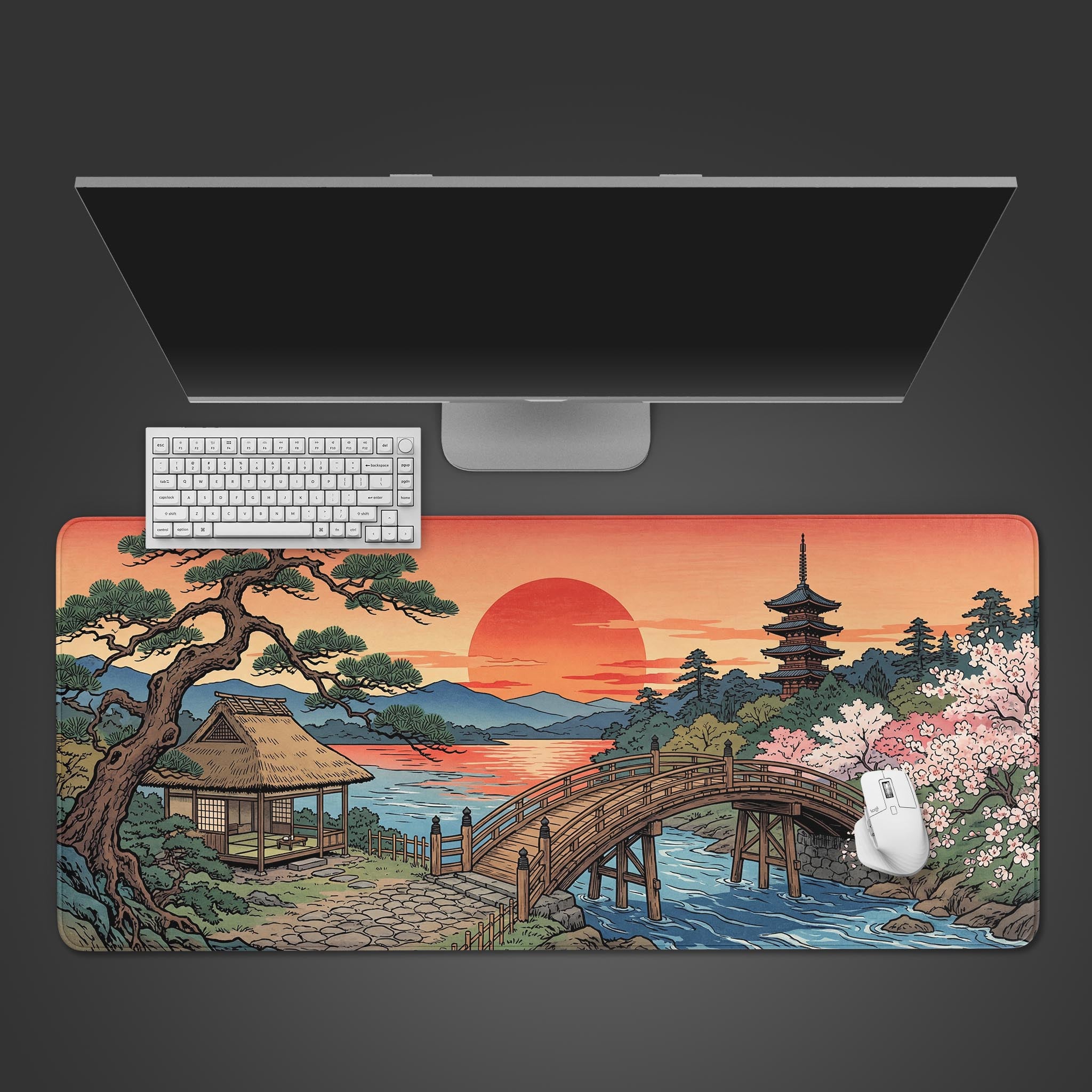 A top-down view of the Sun Setting Japanese Ukiyo-e gaming desk mat, featuring a white keyboard and mouse on a serene landscape design with a bridge and pagoda. - Epic Design Pads & Mousepads