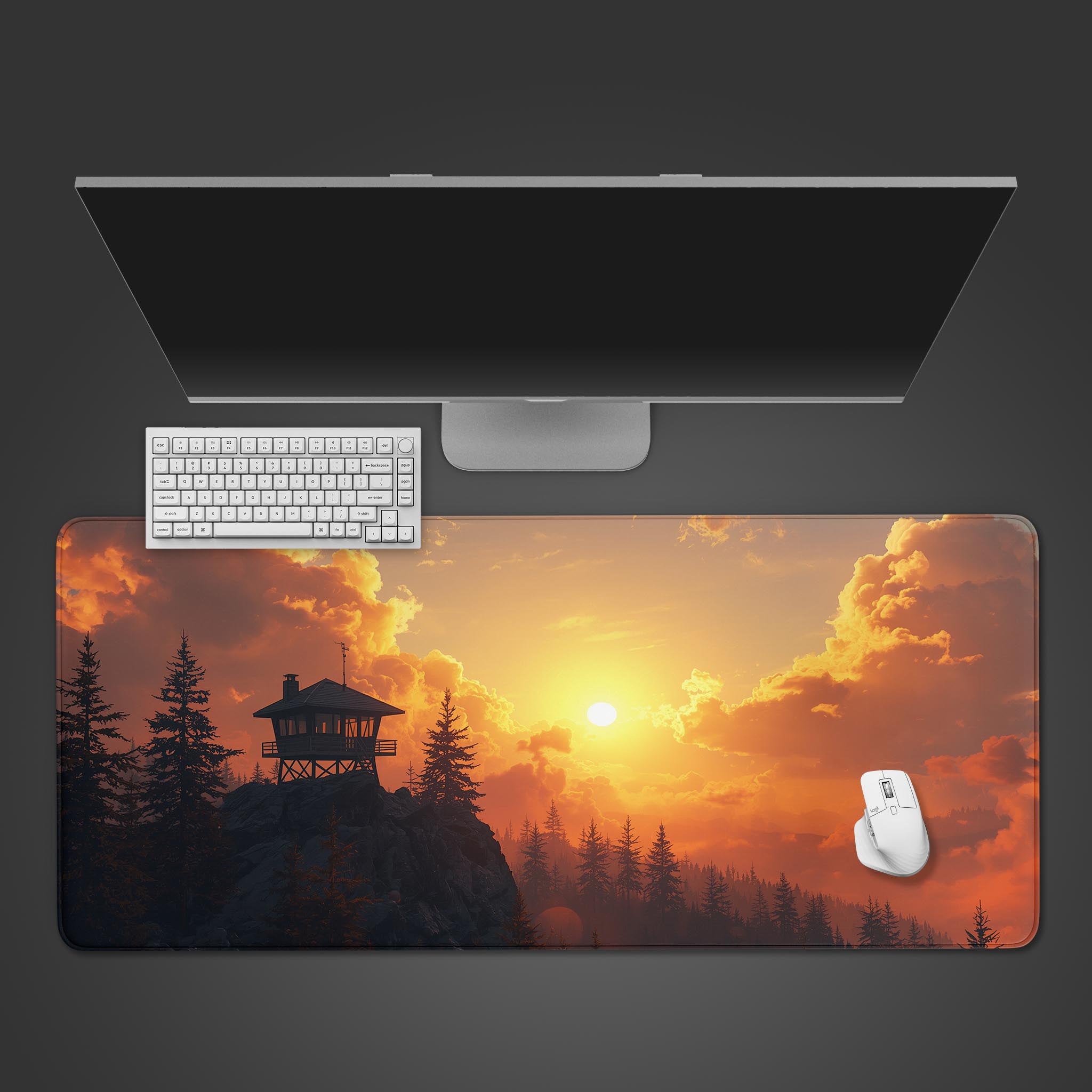 Sunset Lookout desk mat with a fire cabin design – shown in a desktop view with a keyboard and mouse, highlighting the vibrant sunset colors. - Epic Design Pads