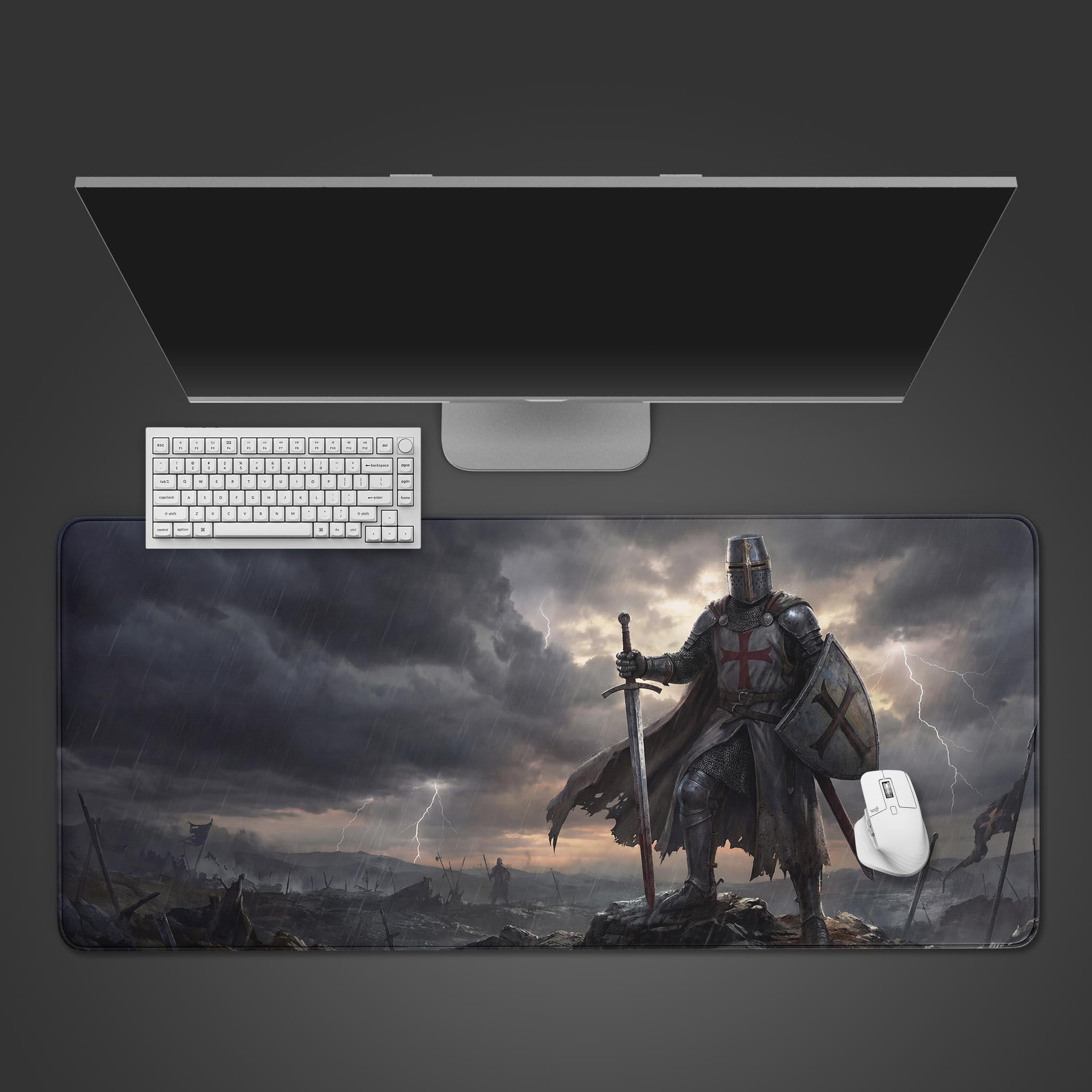 Top-down view of the Templar's Stand gaming desk mat featuring a knight in a storm, shown with a white keyboard and mouse on a grey surface. - Epic Design Pads & Mousepads