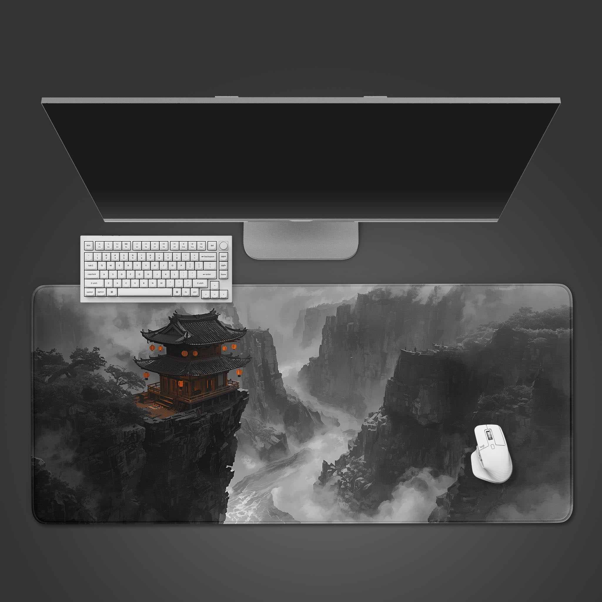 A dark grey desk mat featuring a solitary traditional temple glowing with orange lanterns perched on a dramatic misty mountain cliff.