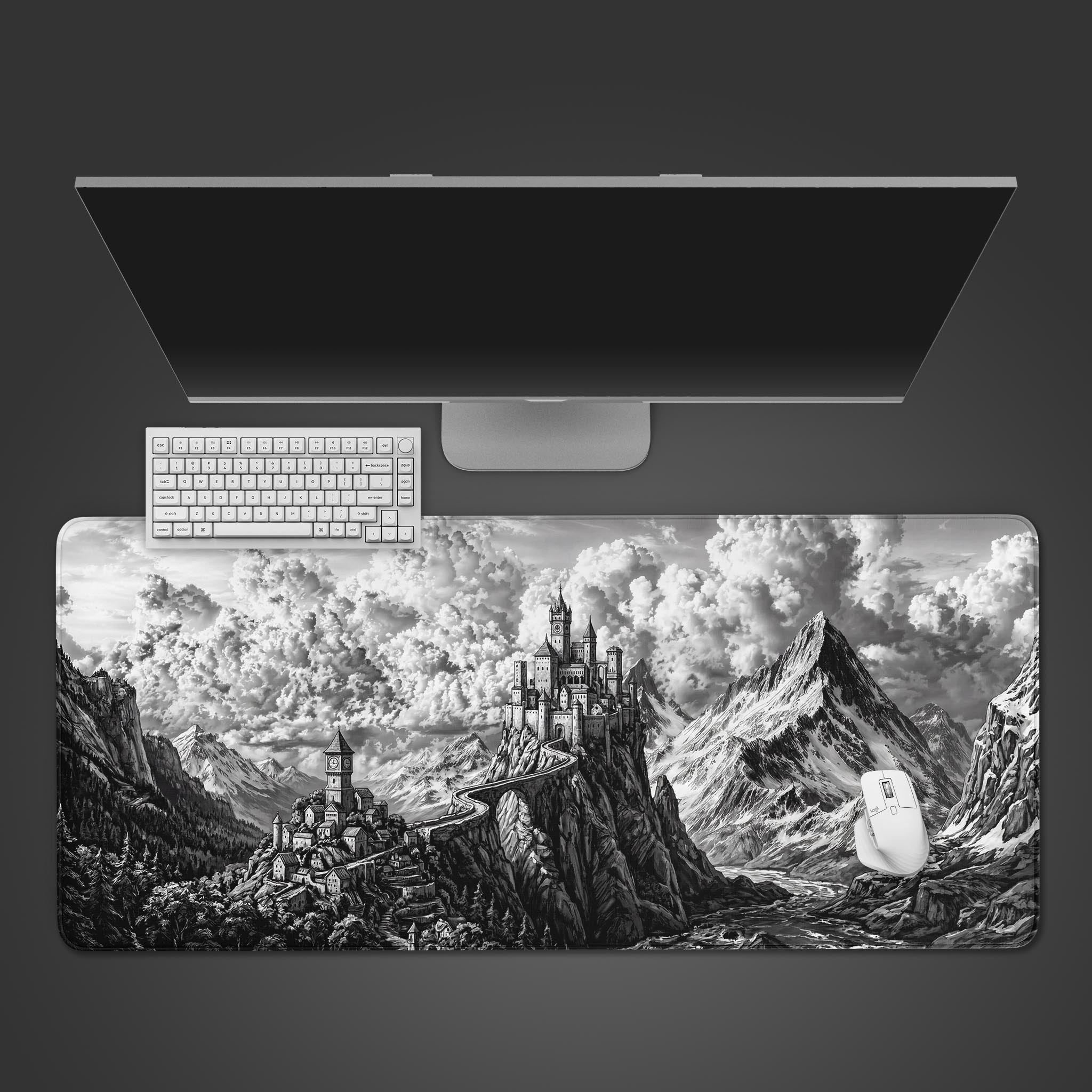 Top-down view of 'The High Keep' gaming desk mat featuring a monochrome fantasy castle, shown with a white keyboard, mouse, and a sleek monitor on a dark surface. - Epic Design Pads & Mousepads