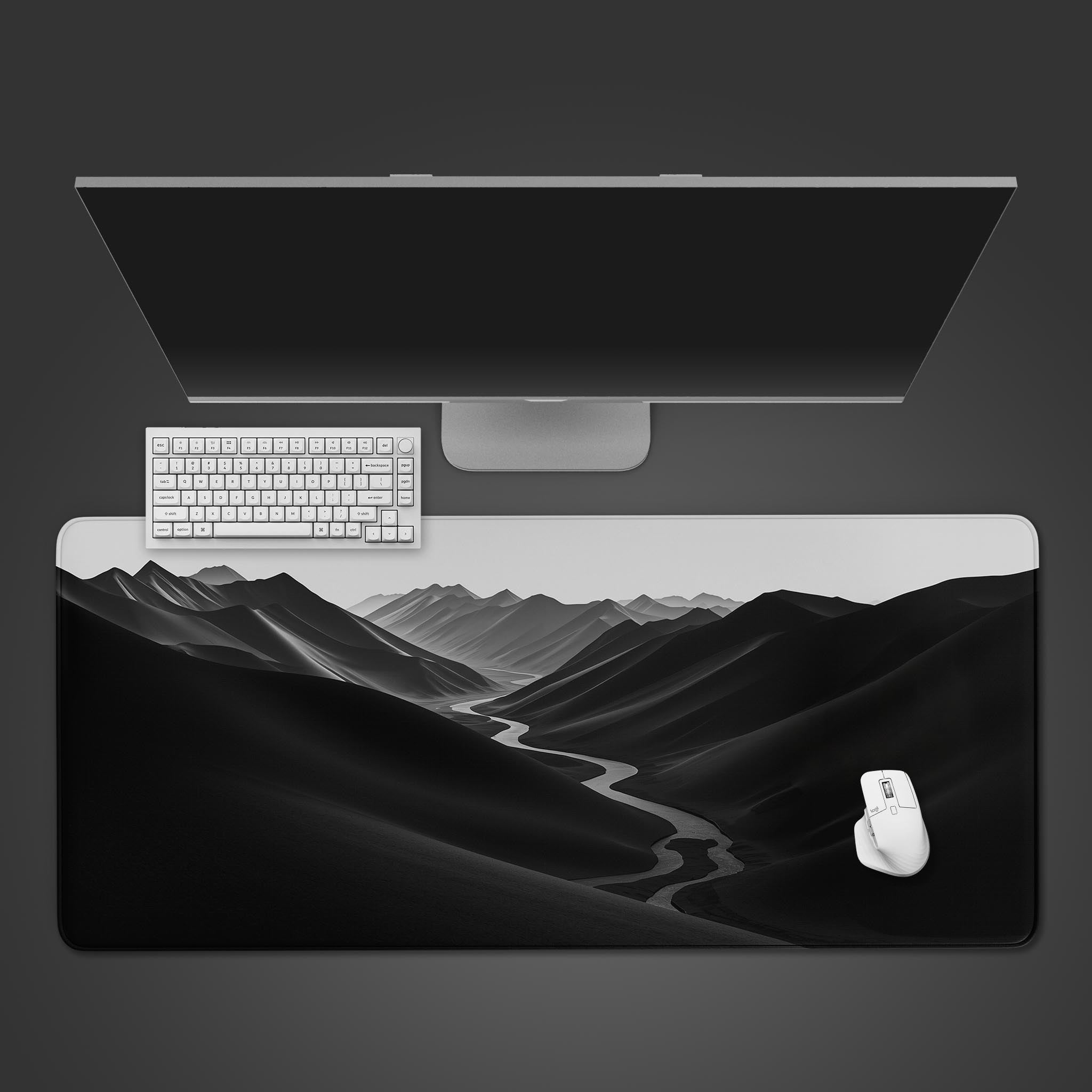 The River Path minimalist desk mat with its stark monochrome river design, shown from a top-down view on a desk with a keyboard and mouse. - Epic Design Pads