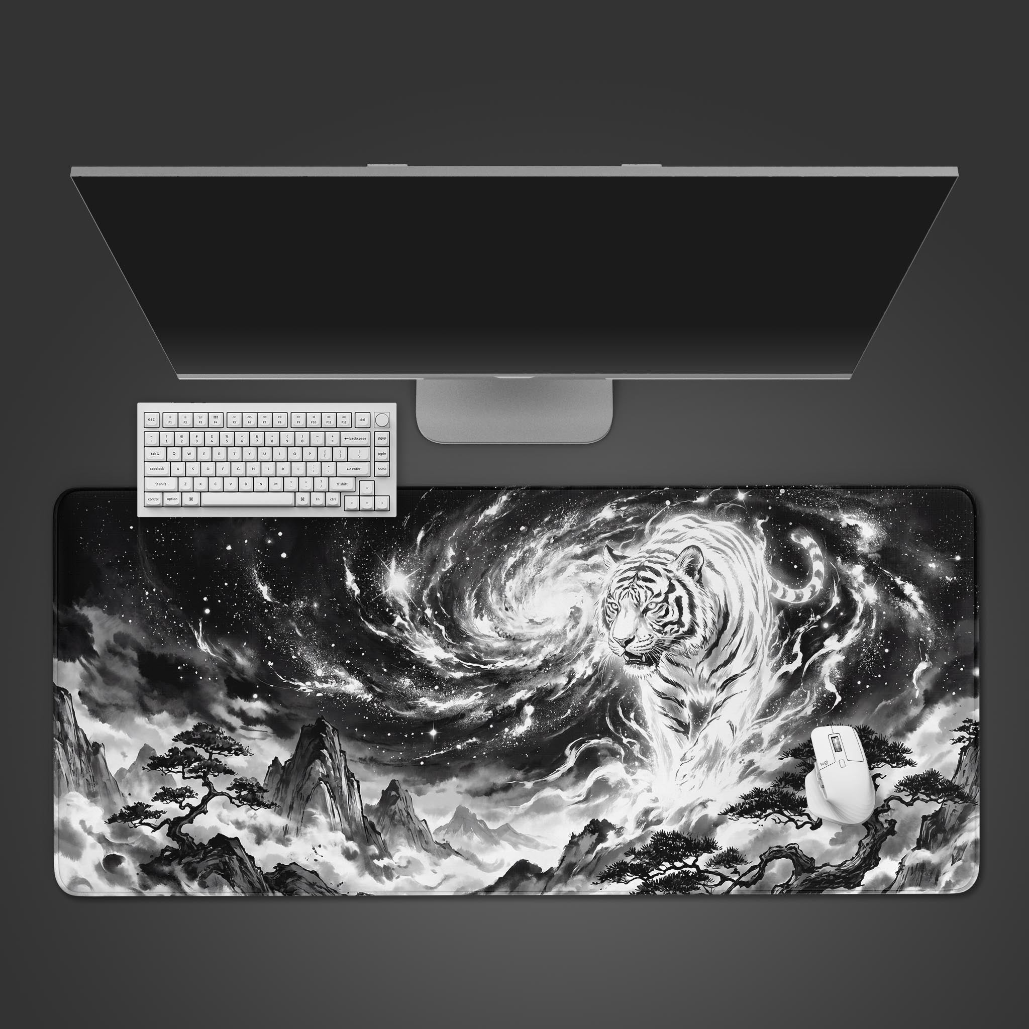 A black and white desk mat featuring a celestial tiger emerging from a swirling galaxy above a mountainous landscape.