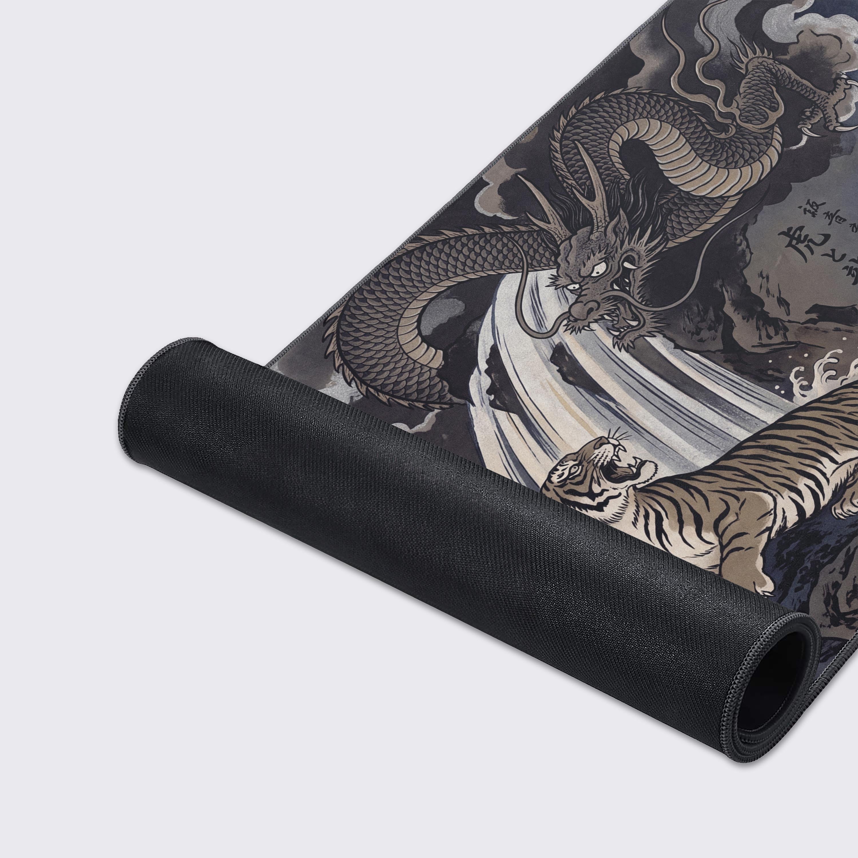 Detail of the desk mat artwork showing an intricate dragon in the clouds, a roaring tiger on a rock, and classic pine trees.