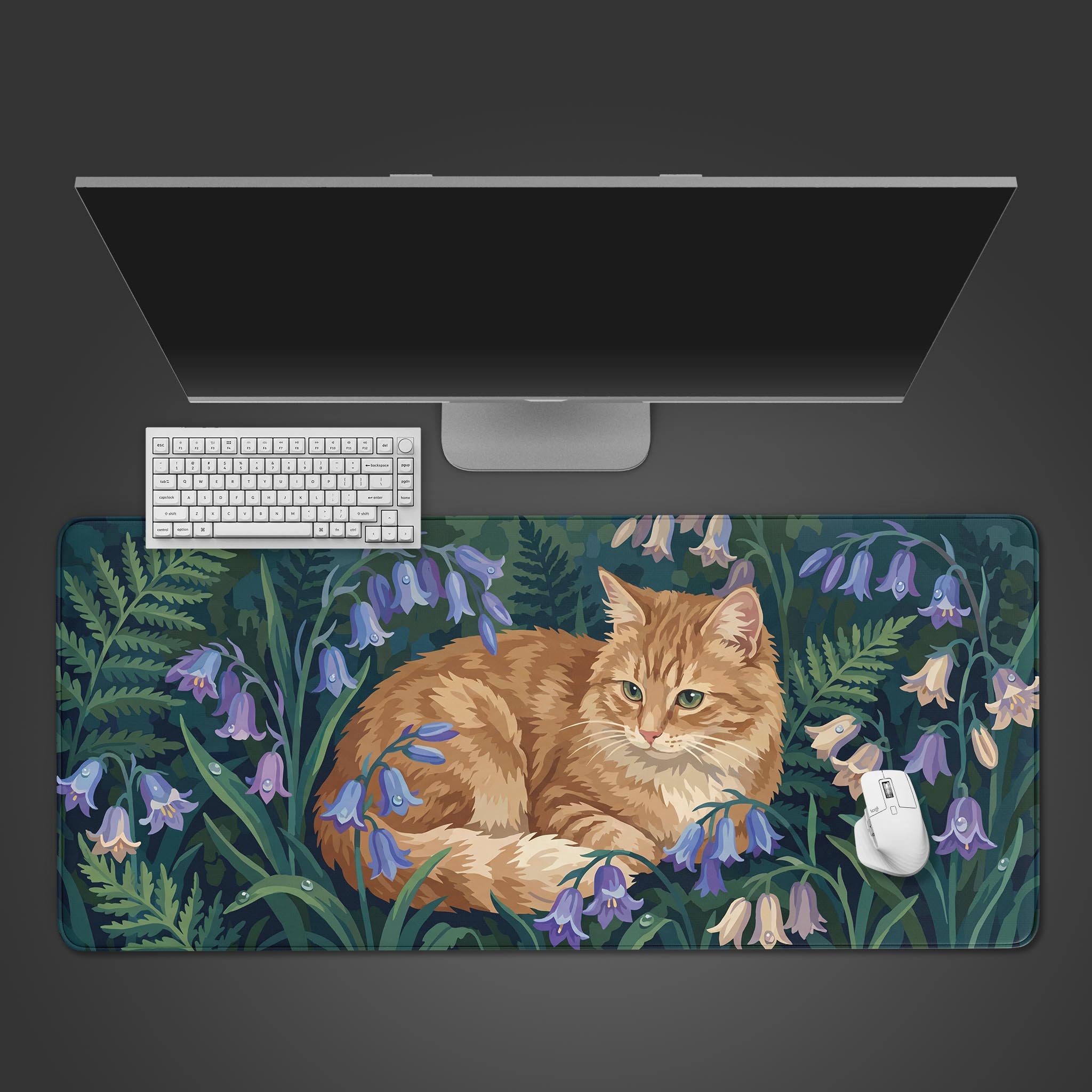 Top-down view of the Tranquil Tabby gaming desk mat with a ginger cat design. A white keyboard, mouse, and monitor complete the clean and artistic desk setup. - Epic Design Pads & Mousepads