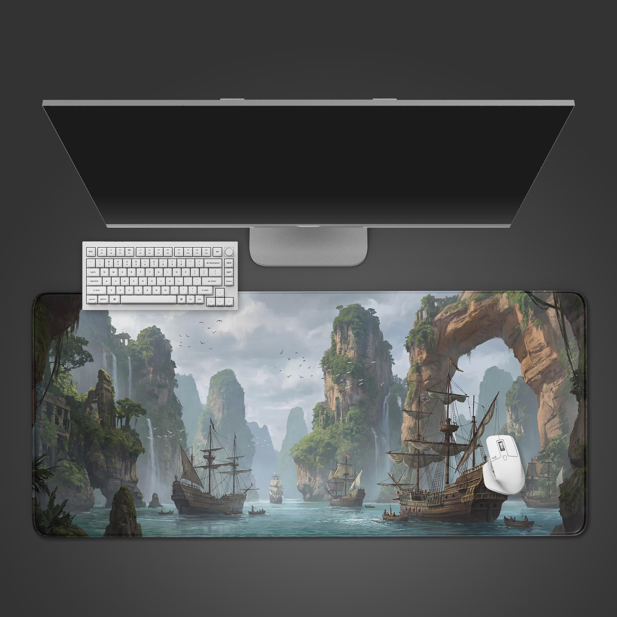 The Verdant Voyage gaming desk mat shown from above, featuring a fantasy landscape of pirate ships and cliffs, with a keyboard and mouse. - Epic Design Pads & Mousepads