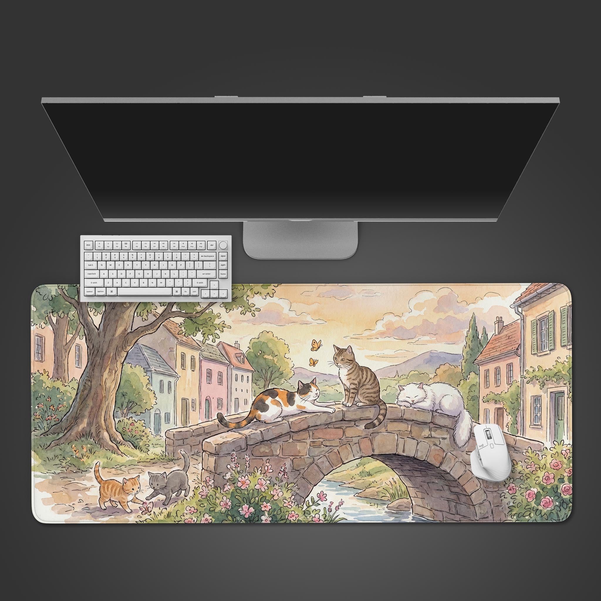 Village Cat Bridge desk mat featuring a watercolor illustration of cats resting on a stone bridge