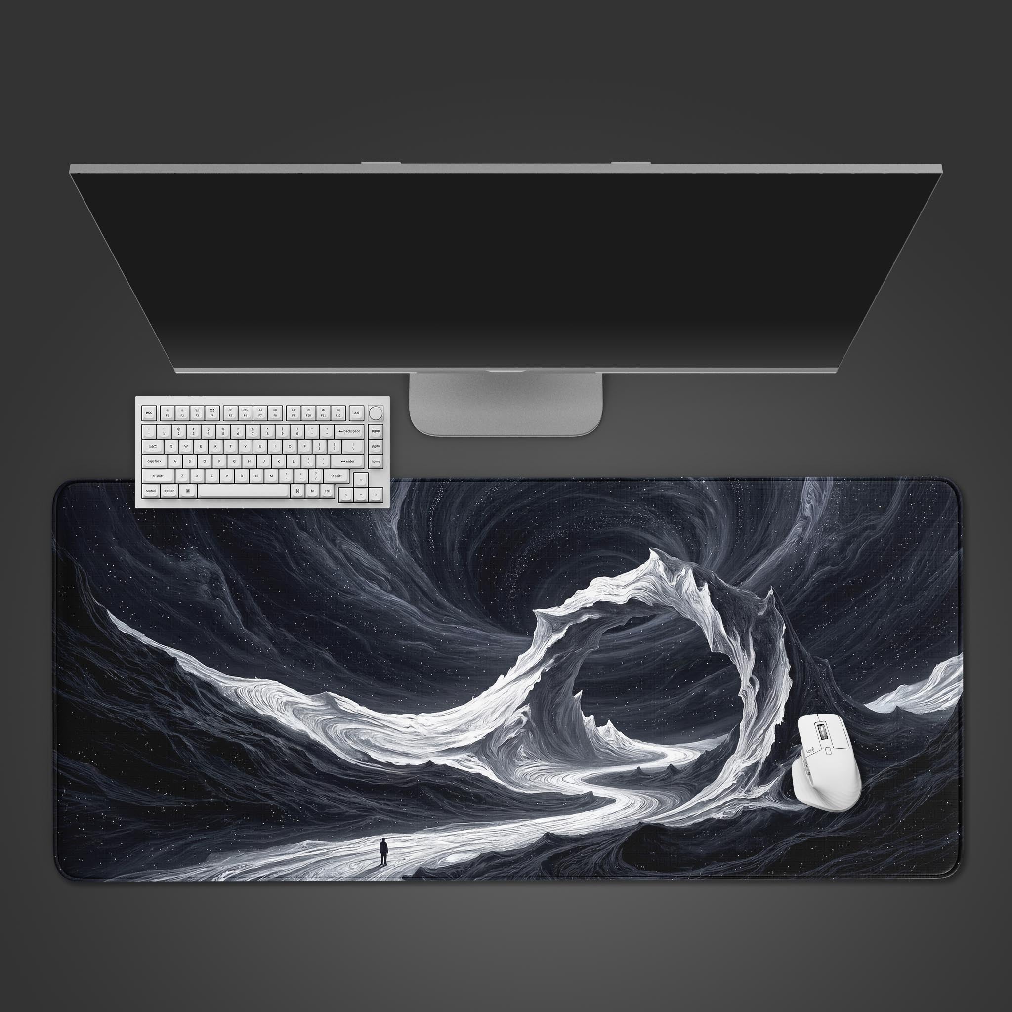 Top-down view of the Void Walker gaming desk mat featuring a monochrome cosmic landscape, shown with a white keyboard and mouse on a dark desk. - Epic Design Pads & Mousepads
