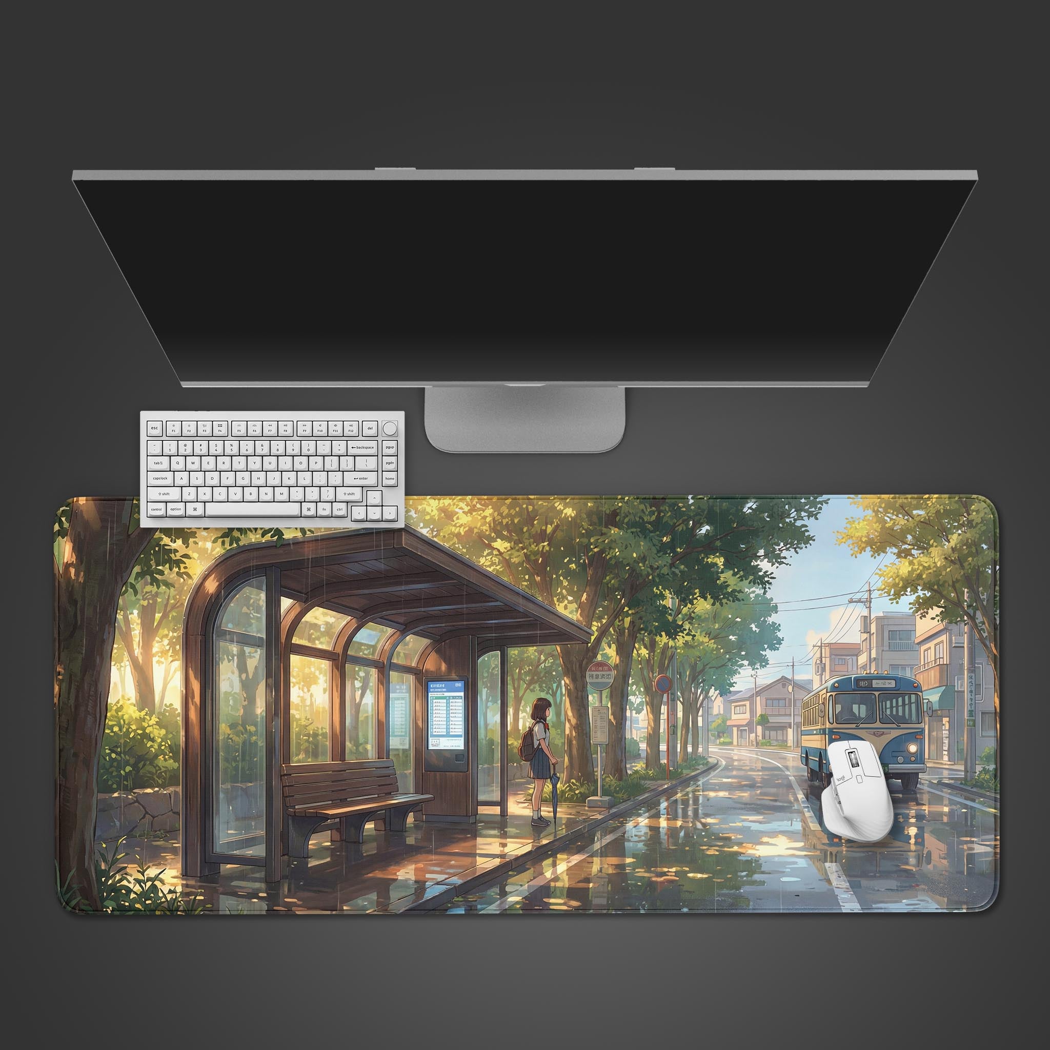 Top-down view of the 'Waiting for Home' gaming desk mat, showing the anime bus stop scene beneath a white keyboard, mouse, and a large monitor. - Epic Design Pads & Mousepads