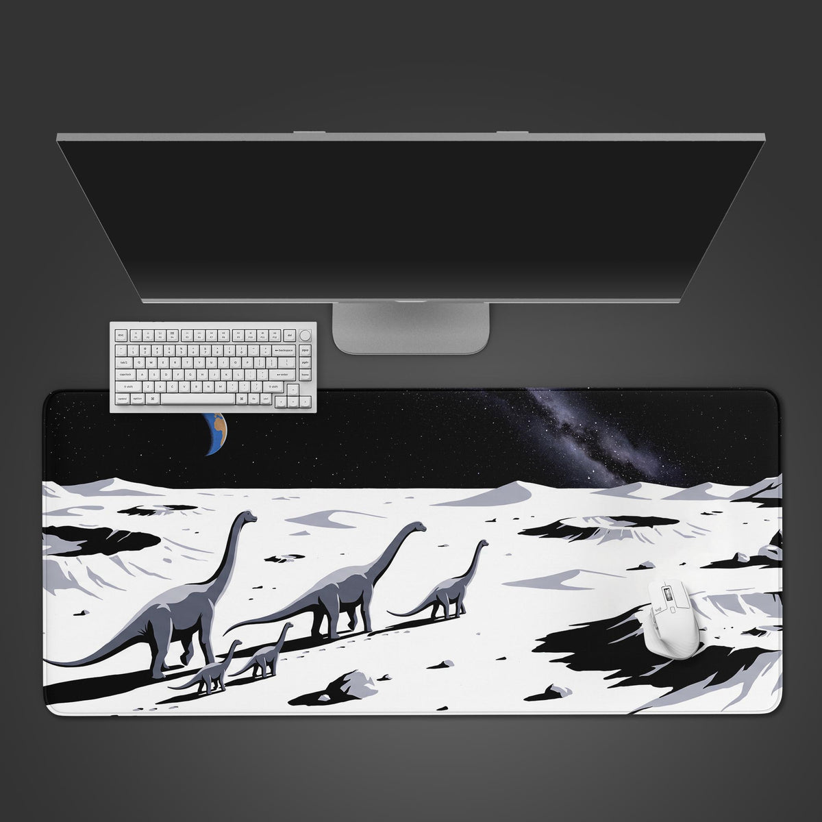 White dinosaur space desk mat seen from above with a monitor, white keyboard and mouse, sauropods crossing a white moonscape