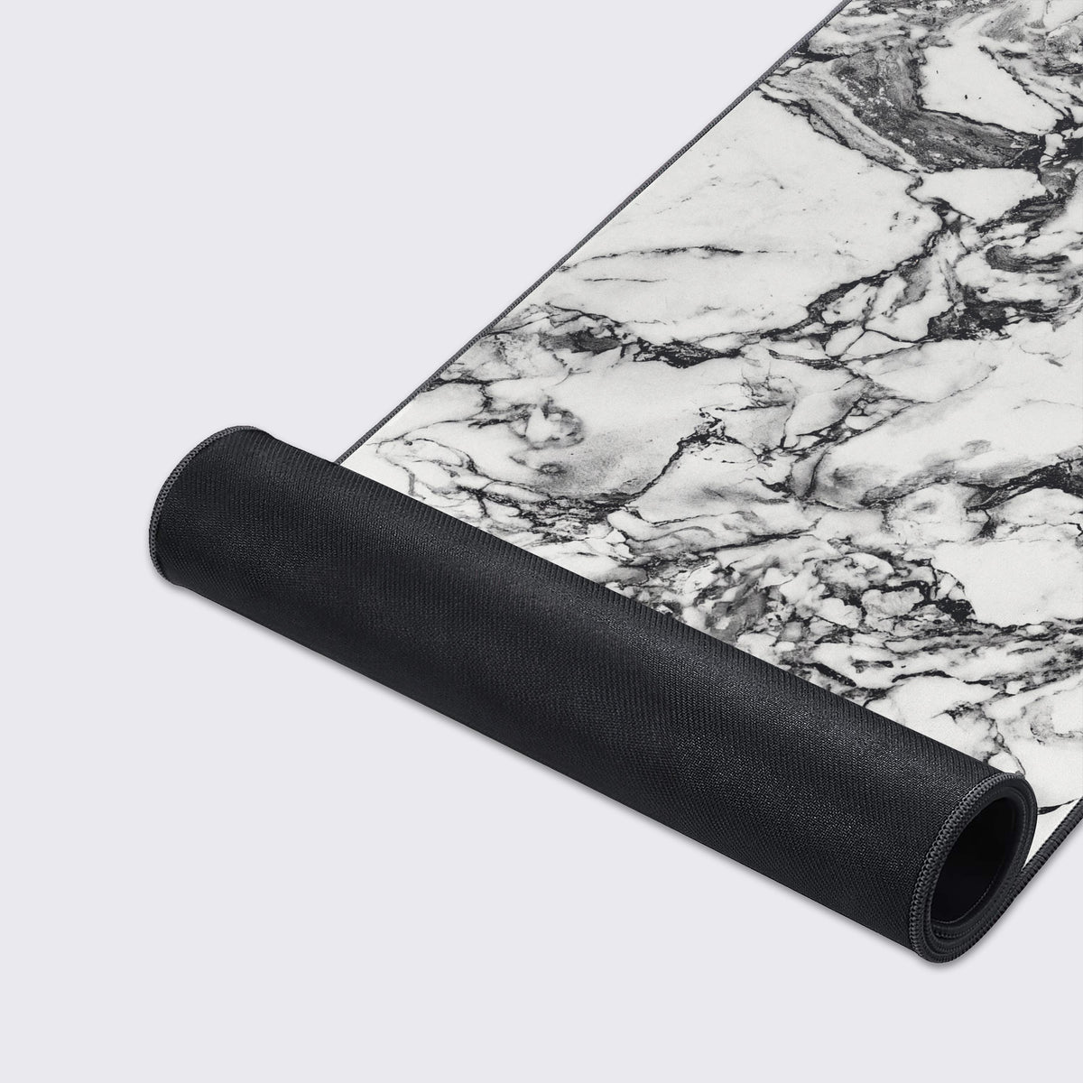 The white marble desk mat shown hovering above a reflective surface, showcasing its clean and elegant aesthetic.