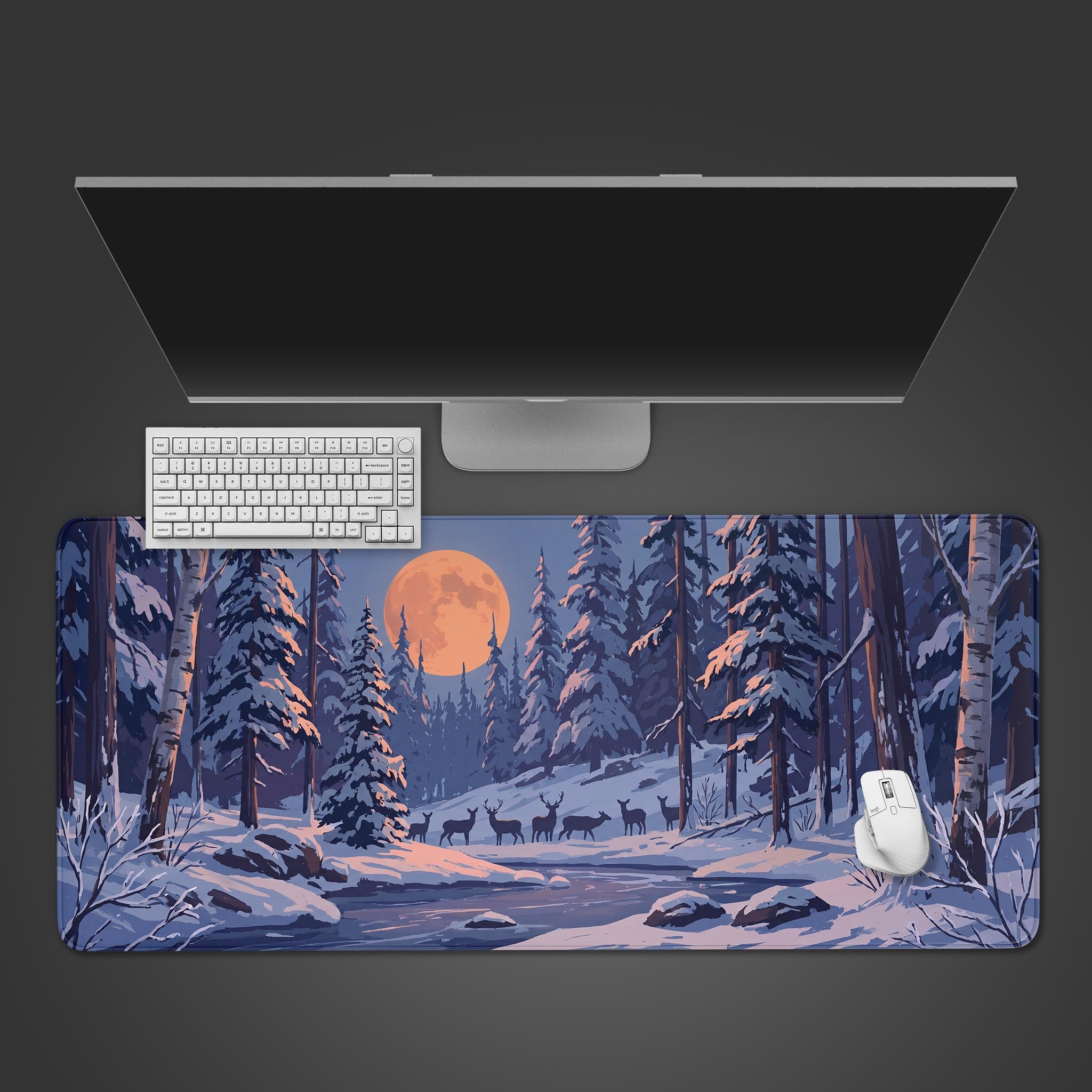 A desk mat featuring a serene winter forest landscape with snow-covered trees and a glowing orange full moon