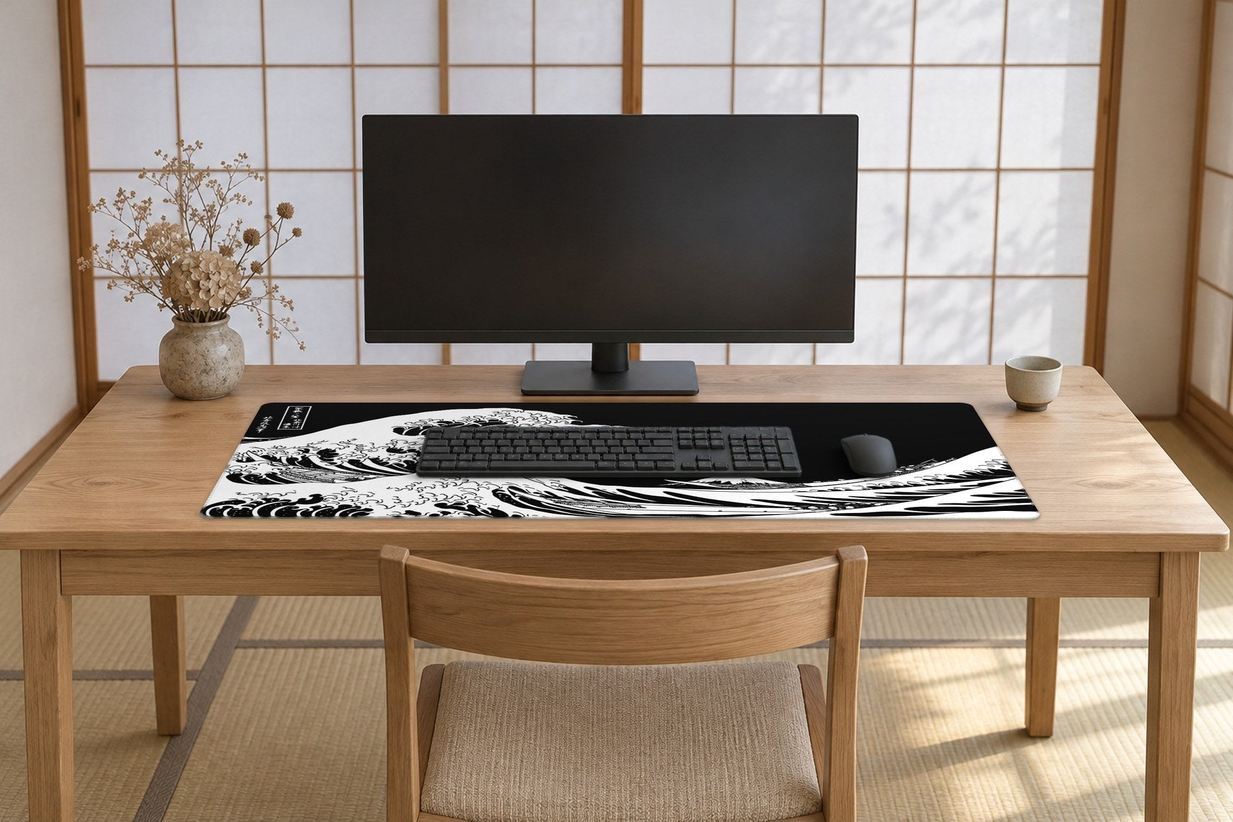 A calm Japanese-style room with paper-screen windows letting in soft morning light, a pale ash wood desk and chair, and a large black and white Great Wave desk mat spread across the desk.