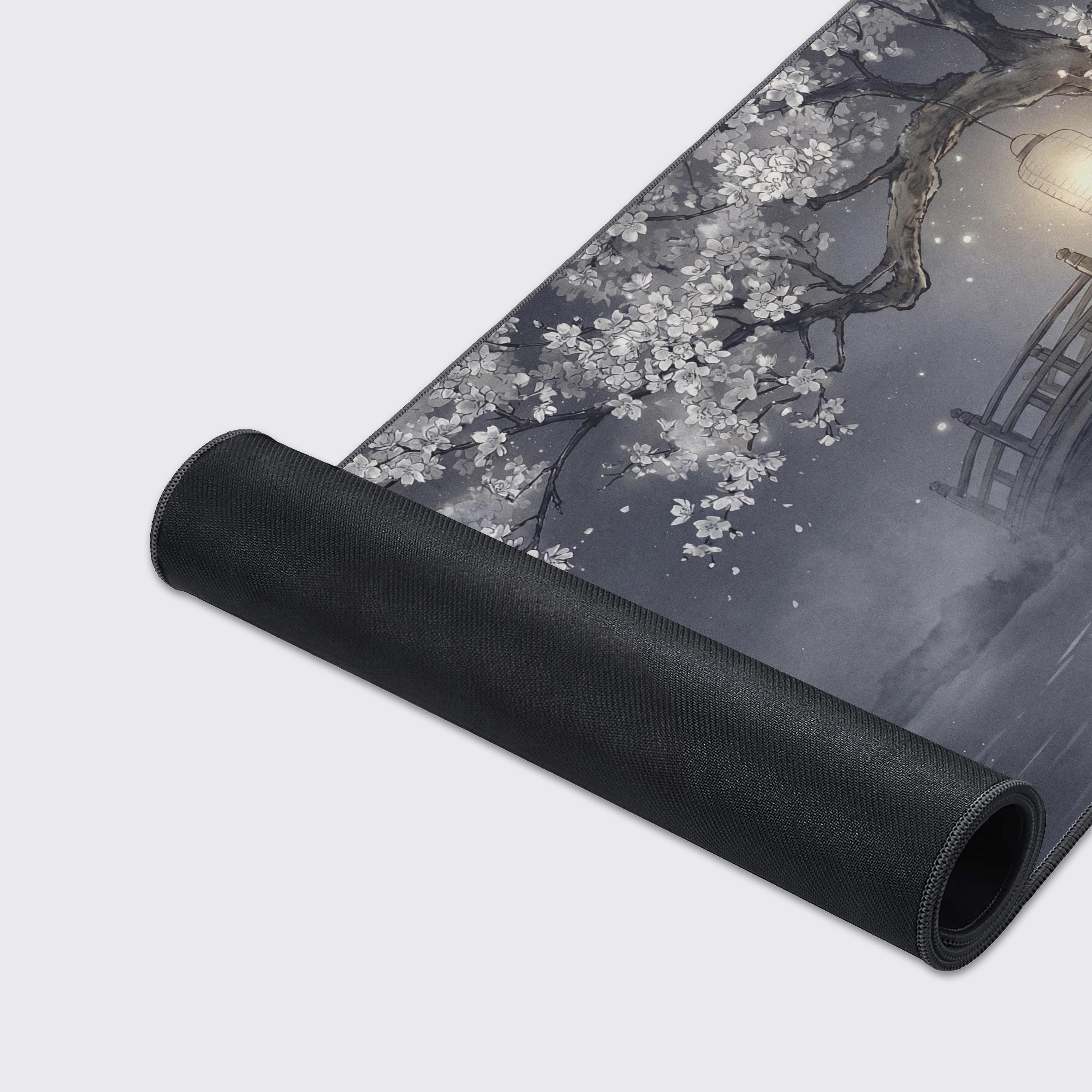 A close-up of the Silent Crossing Gaming Desk Mat highlighting its smooth fabric texture and durable stitched edges, with the serene monochrome bridge and tree art. - Epic Design Pads & Mousepads