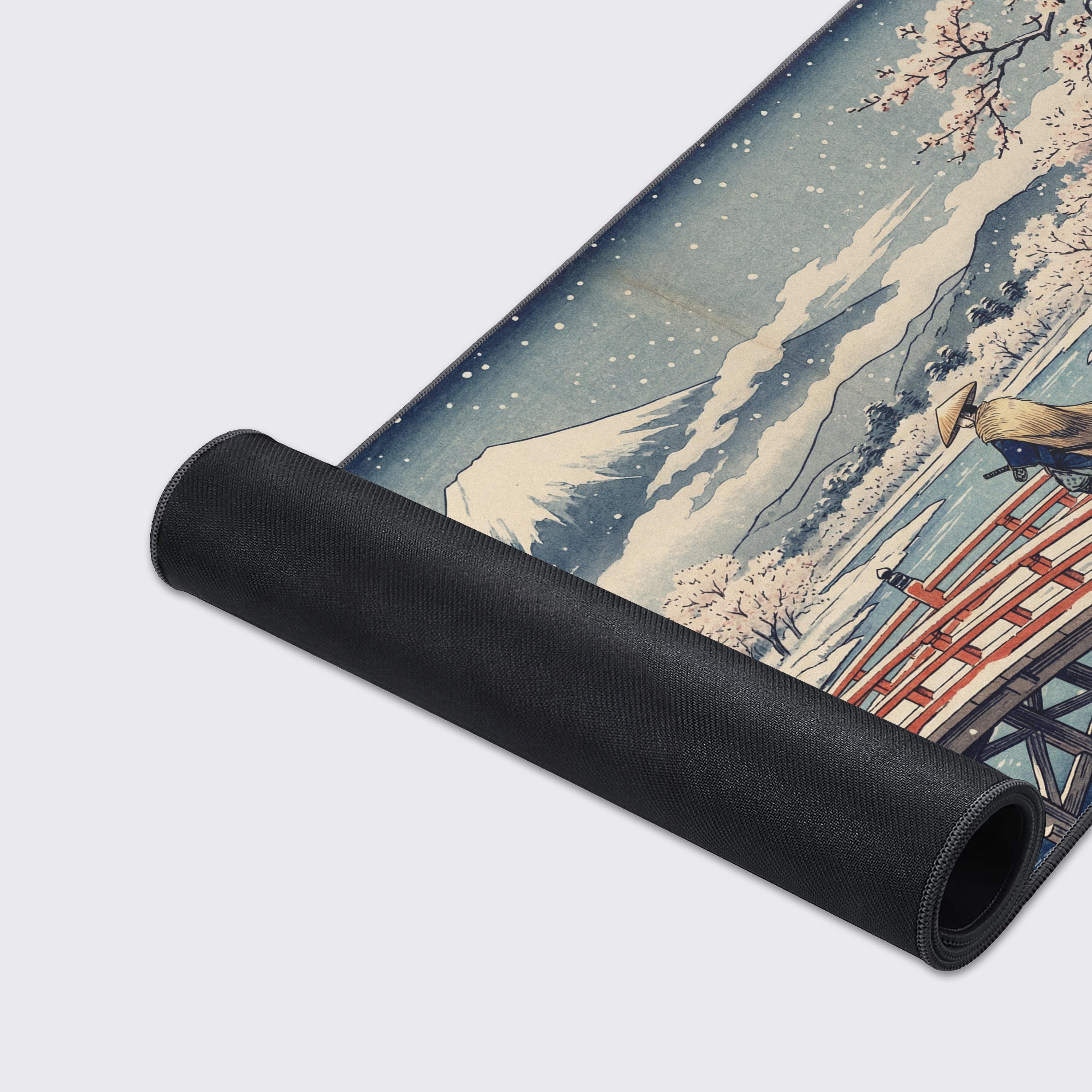 A close-up of the Winter Zen Path gaming desk mat, highlighting the fine fabric texture, durable stitched edges, and the detailed artwork of a samurai on a snowy bridge. - Epic Design Pads & Mousepads