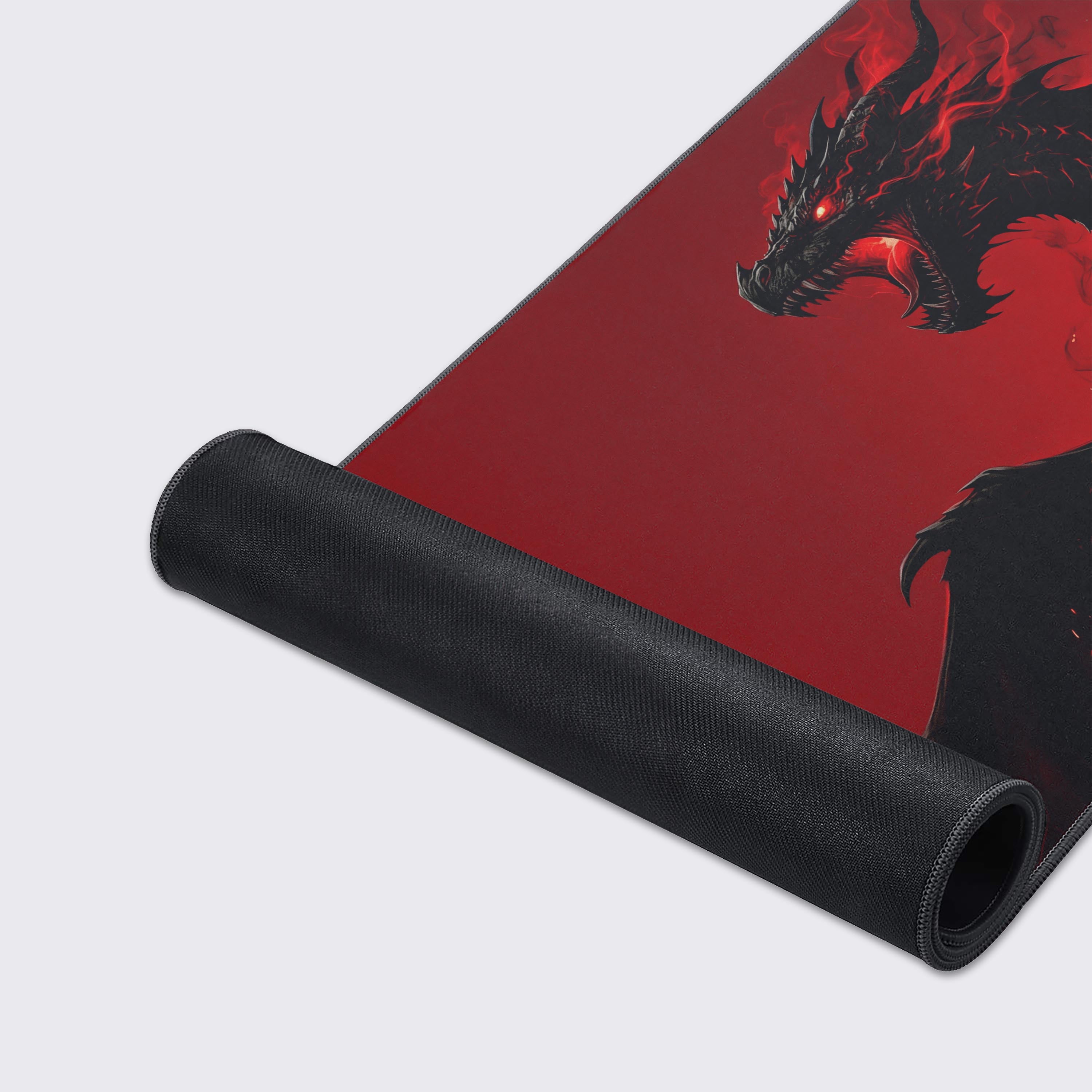 Close-up of the Unbound Fury gaming desk mat showcasing the smooth fabric texture, stitched edges, and the intricate black dragon artwork. - Epic Design Pads & Mousepads