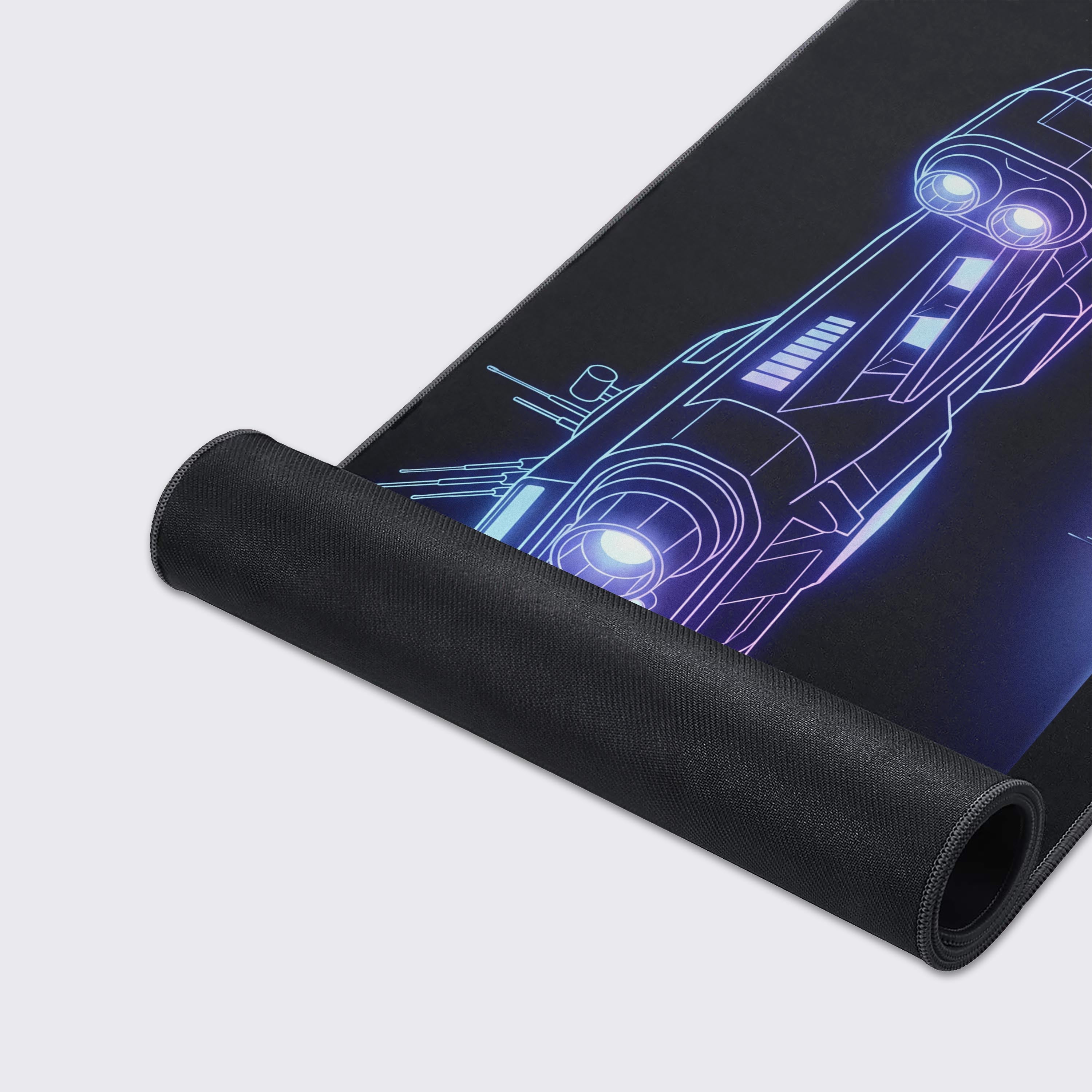A close-up of the Void Schematic gaming desk mat highlighting the durable stitched edges and smooth, textured surface with the neon spaceship design. - Epic Design Pads & Mousepads