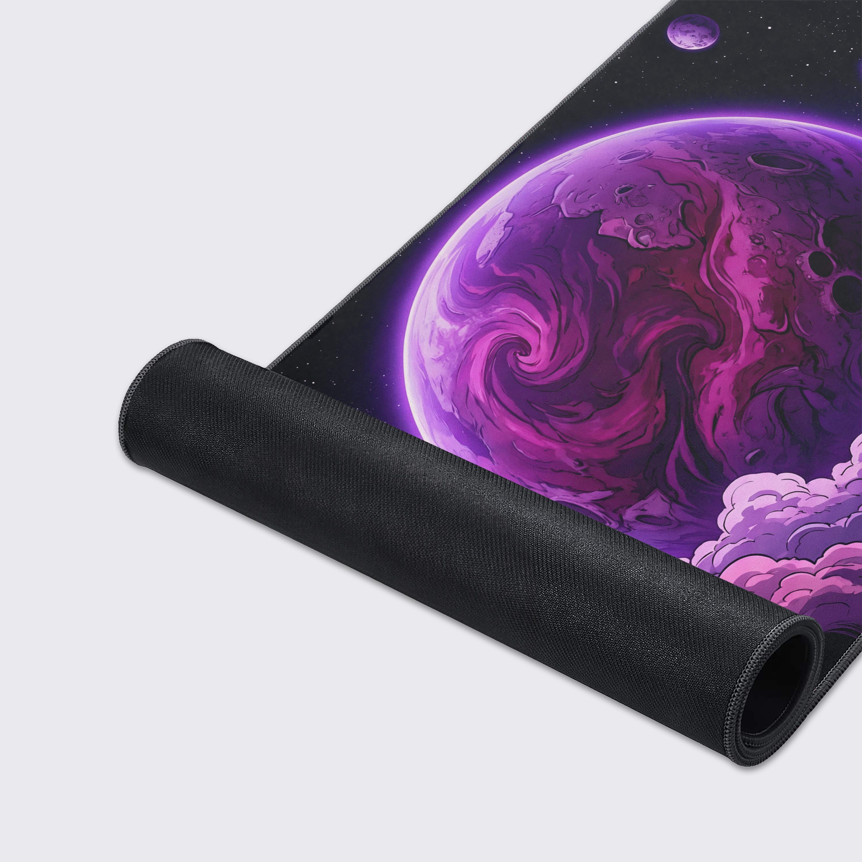 Close-up of the Nebula Core gaming desk mat's smooth texture and stitched edges, highlighting the detailed purple planet and cloud artwork. - Epic Design Pads & Mousepads