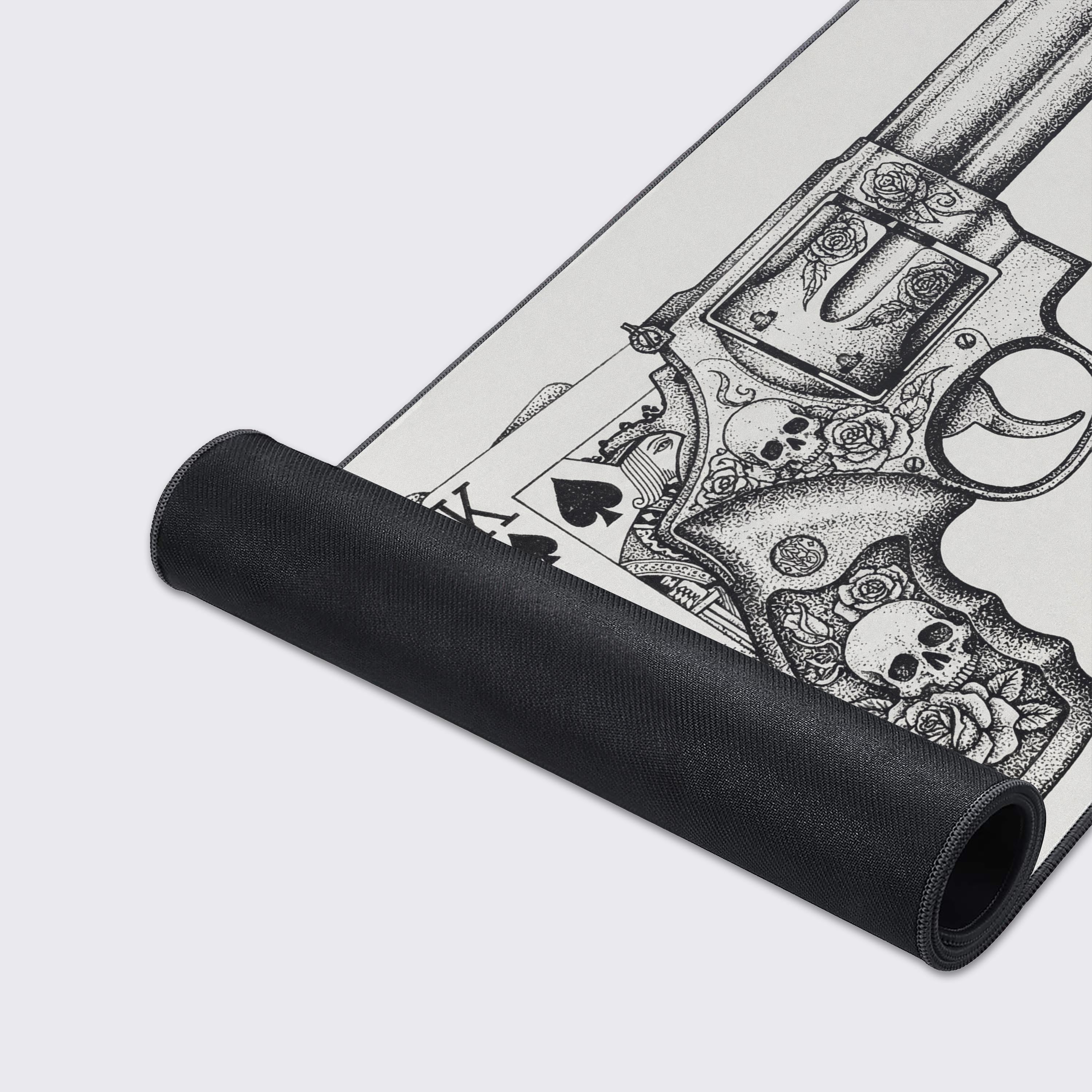 A close-up of the High Stakes gaming desk mat, highlighting the fine stipple art, smooth texture, and durable stitched edges of the gun and skulls design. - Epic Design Pads & Mousepads