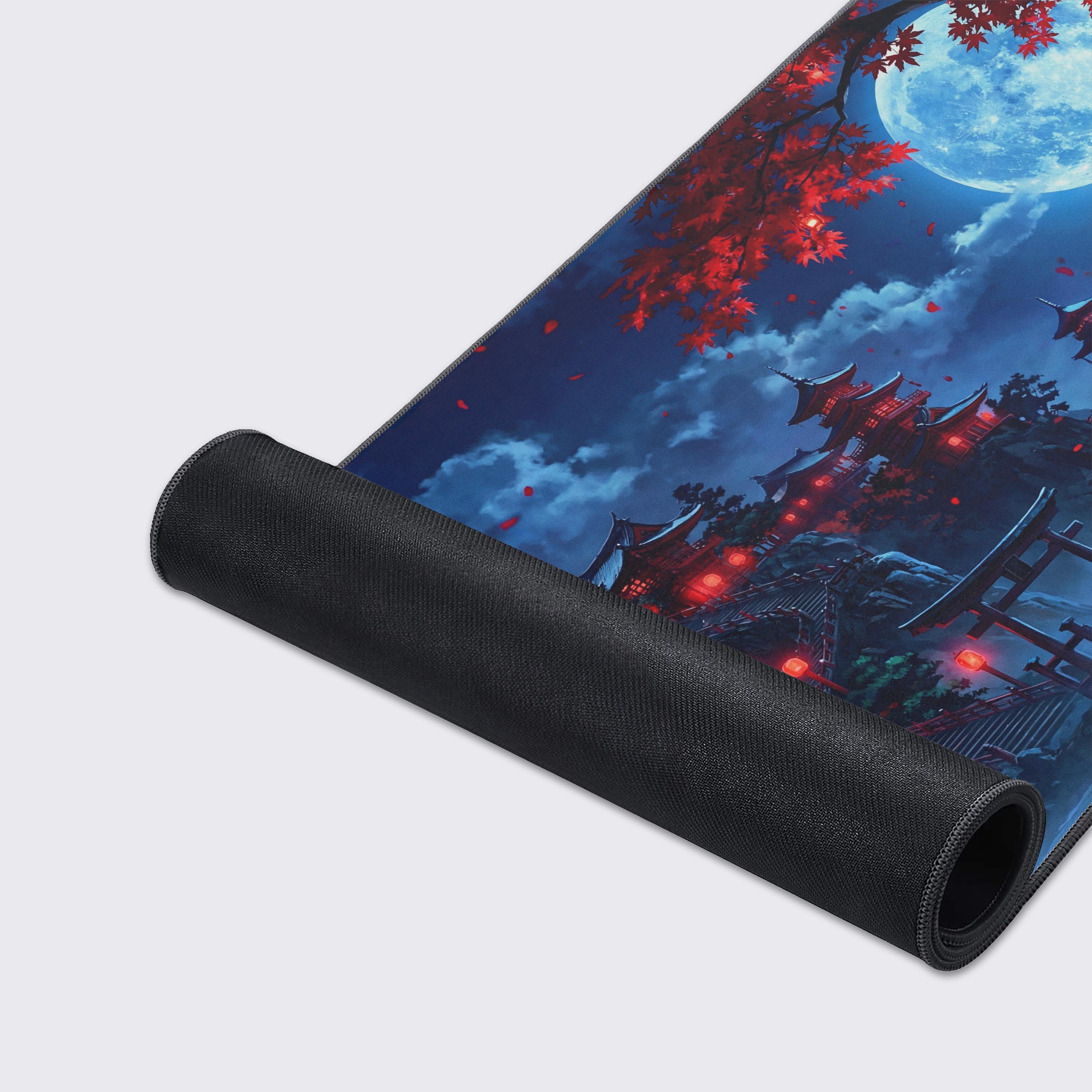 Close-up of the Crimson Shrine mouse pad's smooth fabric texture and stitched edges, showcasing the detailed red moon and temple artwork. A high-quality surface for gaming. - Epic Design Pads & Mousepads