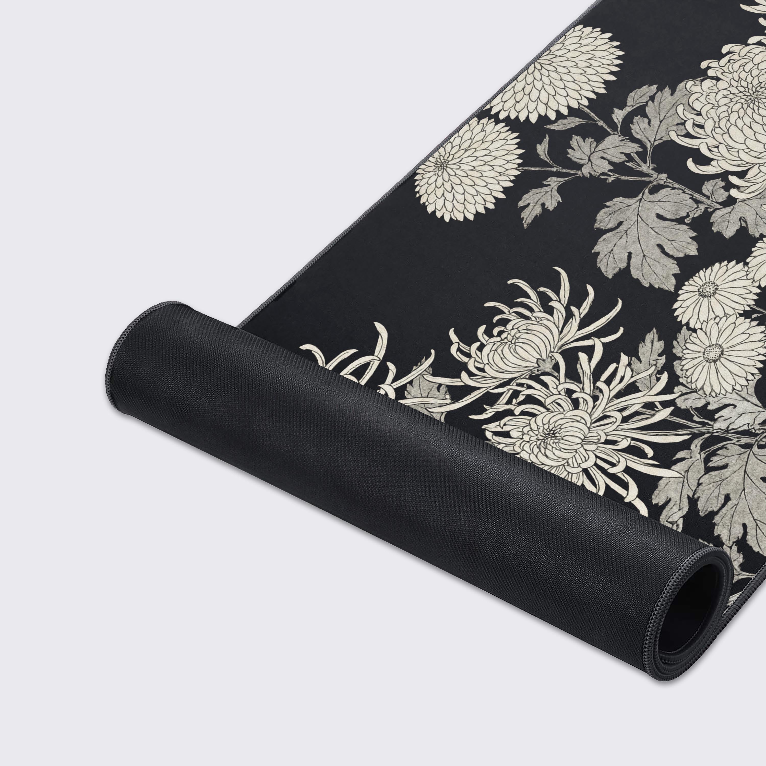 A close-up of the Imperial Noir gaming desk mat highlighting the detailed chrysanthemum artwork, smooth fabric texture, and durable anti-fray stitched edges. - Epic Design Pads & Mousepads