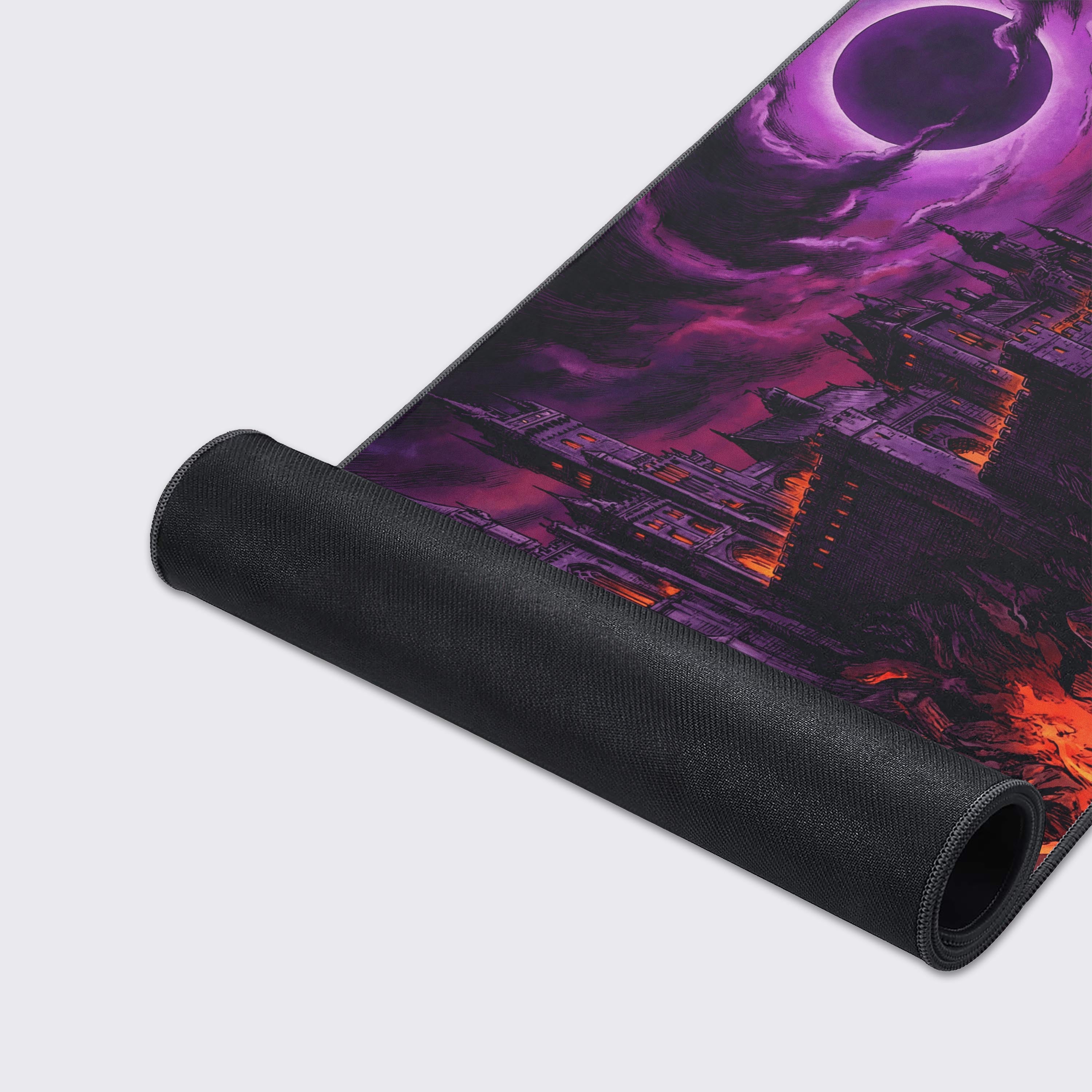 A detailed close-up of the Eclipse Citadel gaming desk mat, highlighting the high-quality stitched edges and smooth fabric texture of the volcanic castle artwork. - Epic Design Pads & Mousepads