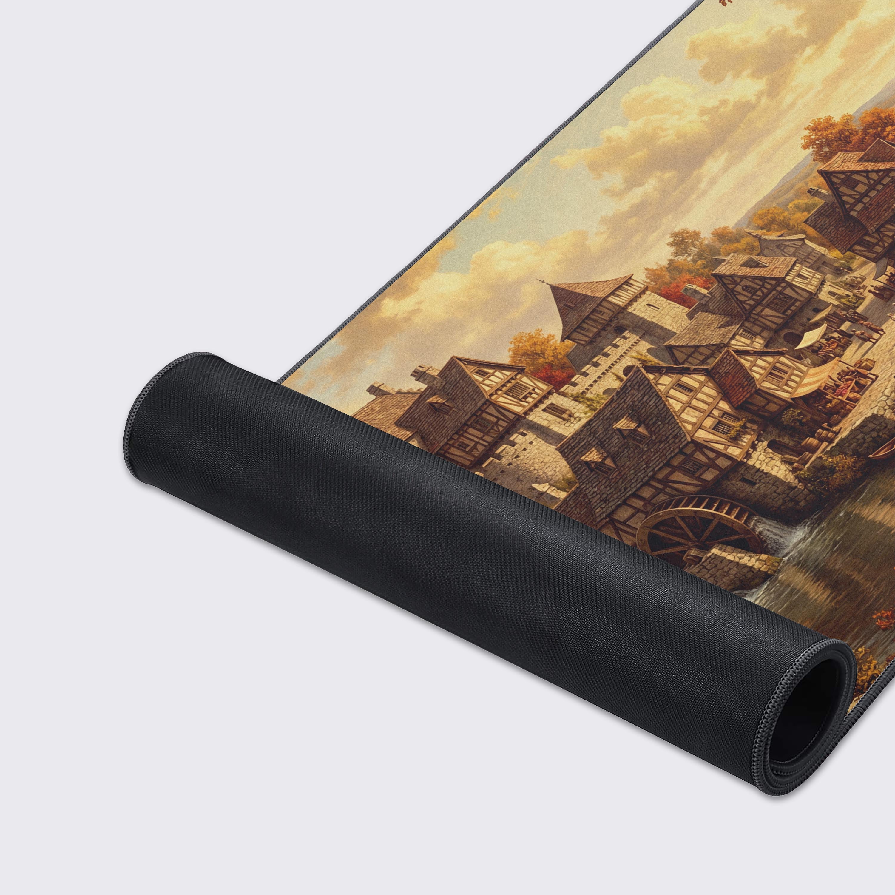 Close-up of the Autumn River Hamlet mouse pad, highlighting the detailed medieval artwork, smooth fabric texture, and durable anti-fray stitched edges. - Epic Design Pads & Mousepads