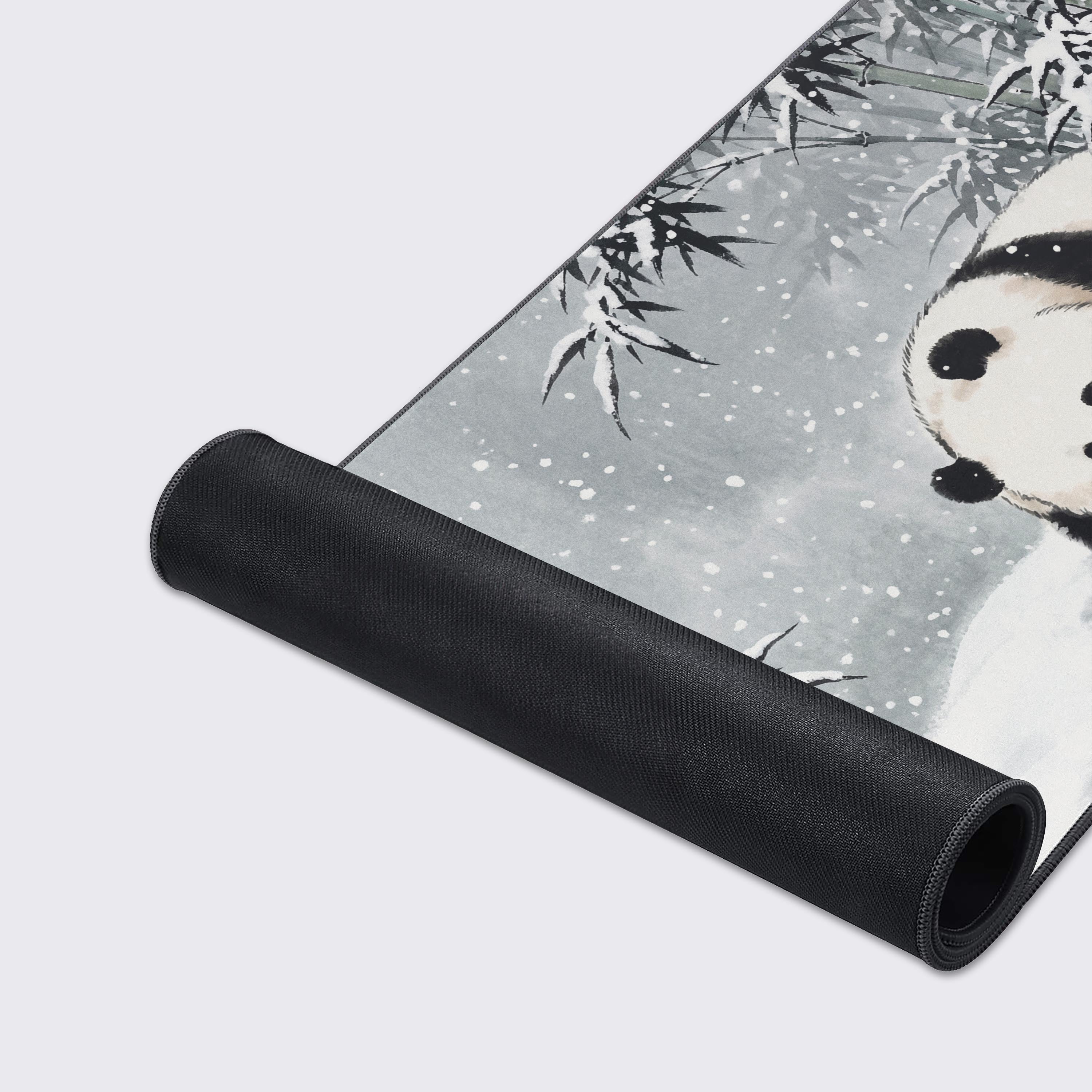 A close-up shot of the First Snow gaming desk mat showcasing the high-quality fabric texture and durable stitched edges. The detailed panda and bamboo ink-wash art is clearly visible. - Epic Design Pads & Mousepads