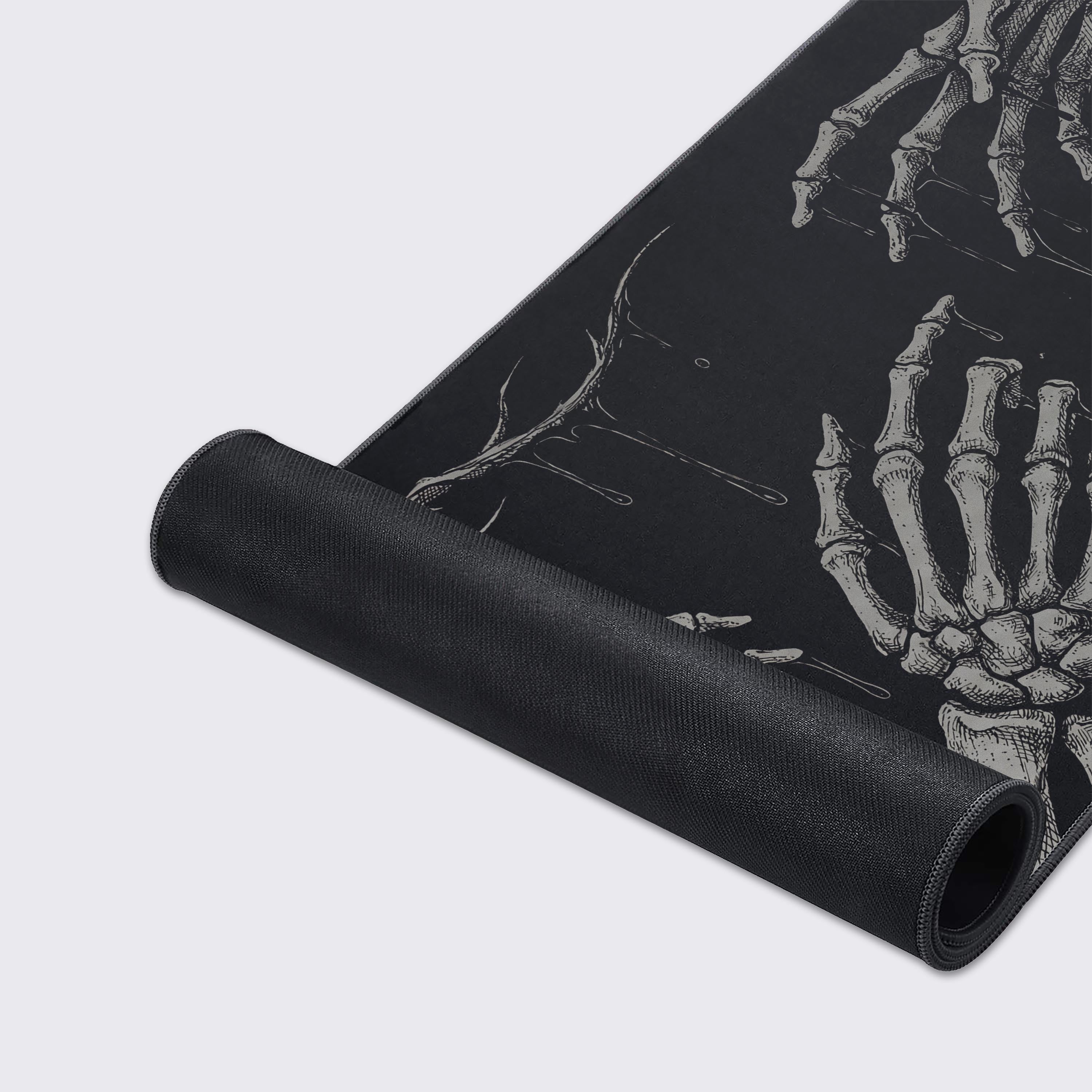 Close-up shot of the Void Touch gaming desk mat highlighting the detailed monochrome skeleton art and the durable stitched edges on the smooth fabric surface. - Epic Design Pads & Mousepads