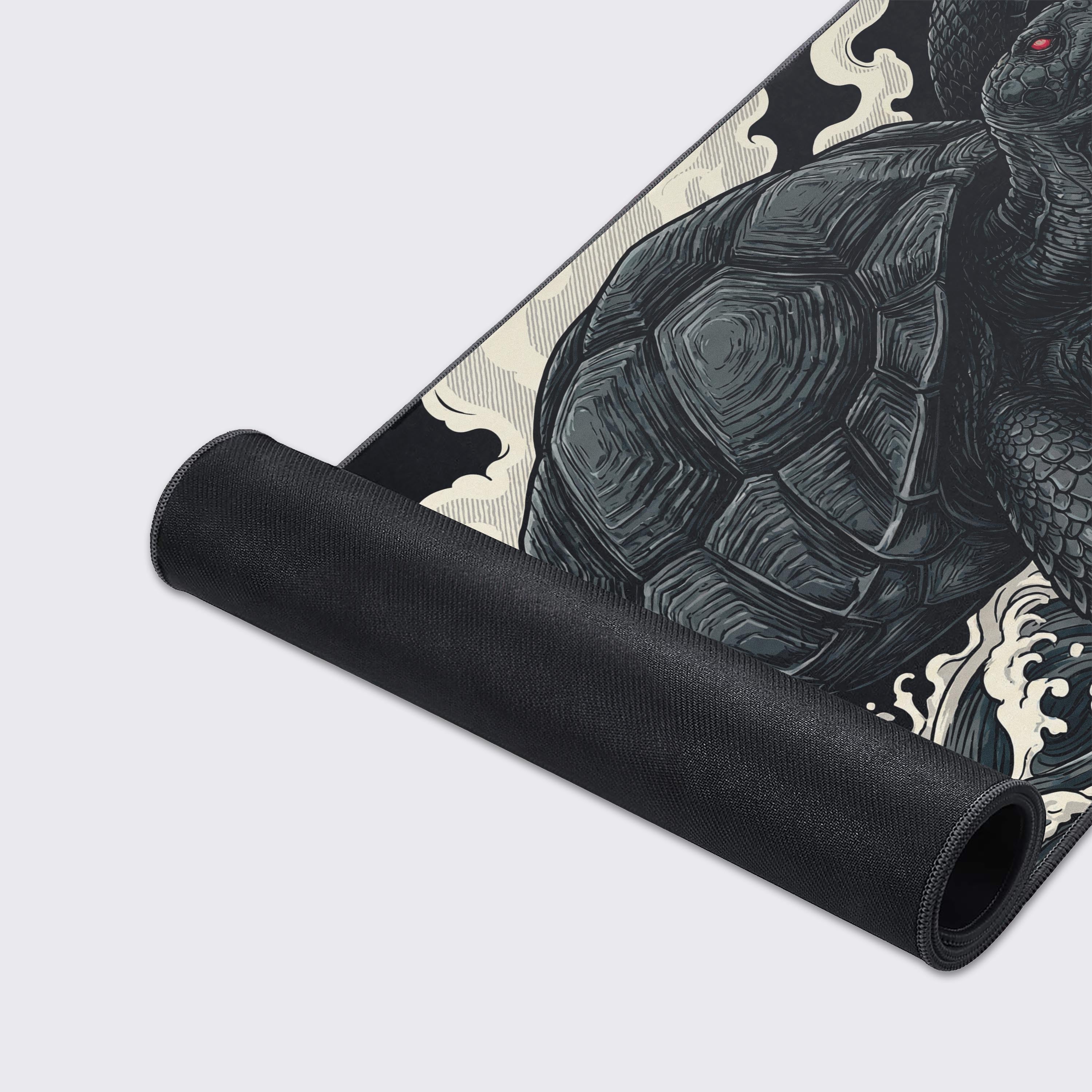 A close-up of the 'Genbu's Wrath' mouse pad, highlighting the smooth fabric texture, stitched edges, and detailed black and white tortoise illustration. - Epic Design Pads & Mousepads