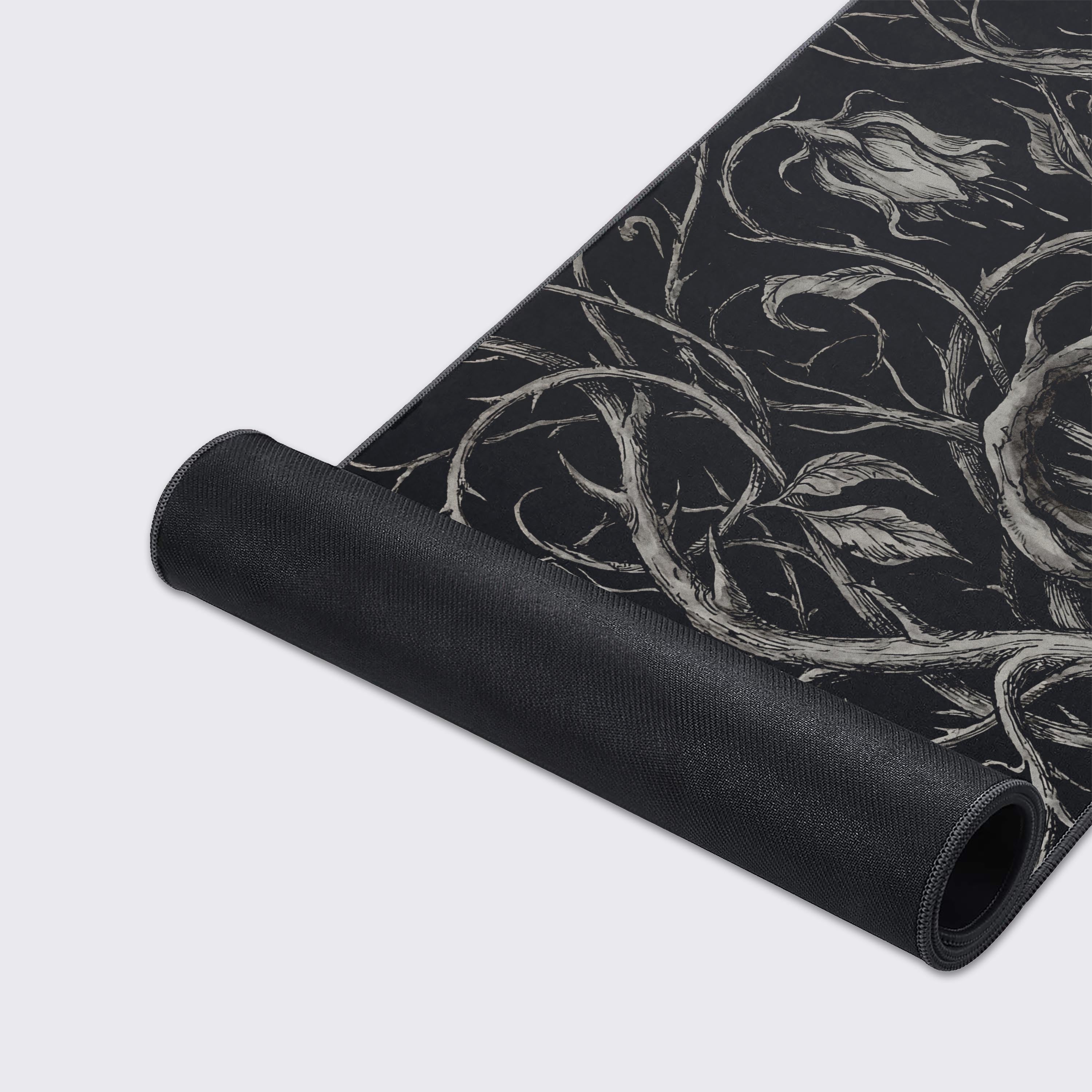 A close-up of the Shadow Vines gaming desk mat, highlighting the detailed ink-style floral artwork and the premium stitched edges of the smooth fabric. - Epic Design Pads & Mousepads