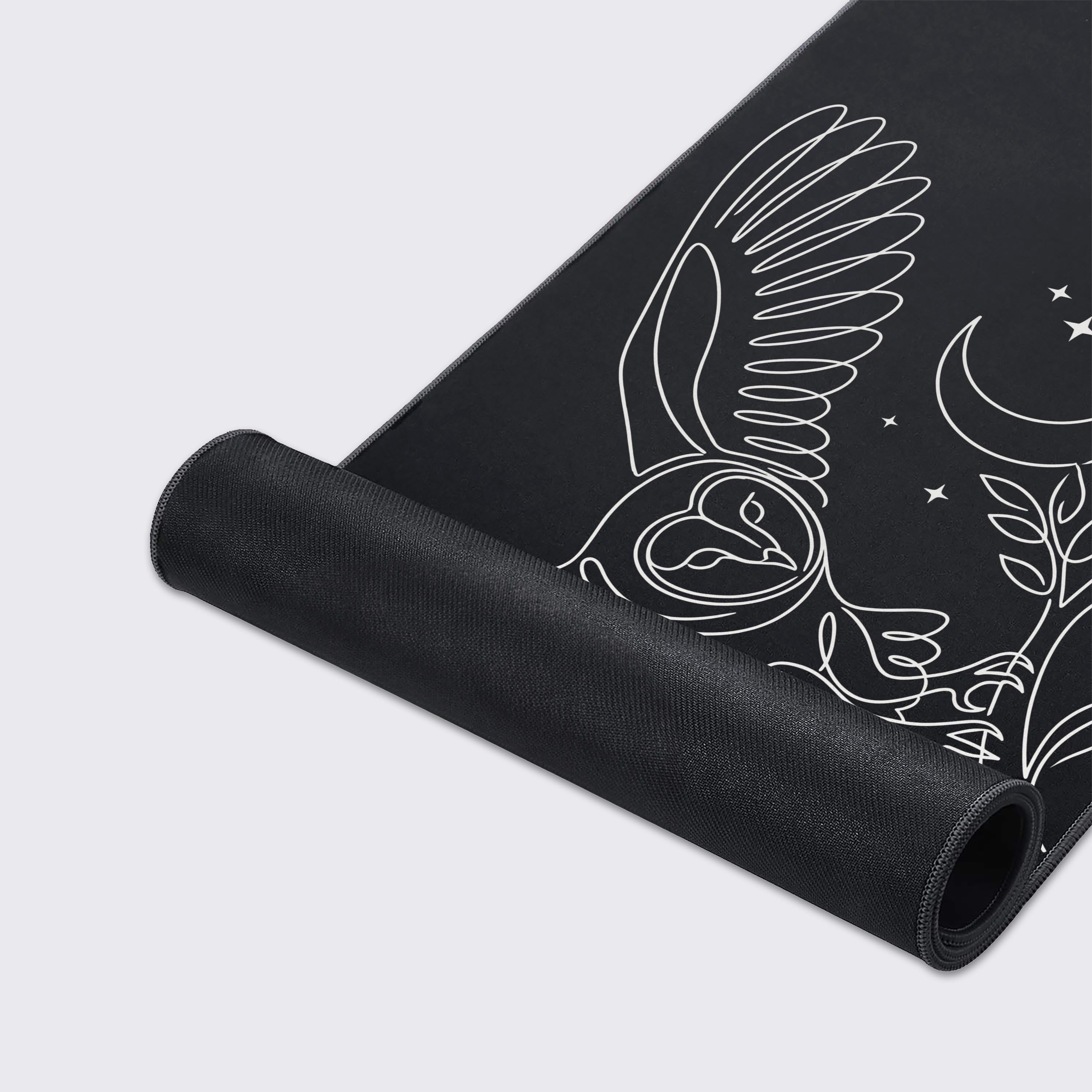A close-up of the Nocturnal Focus gaming desk mat showing the smooth texture and stitched edges, highlighting the detailed white line art of the owl design. - Epic Design Pads & Mousepads