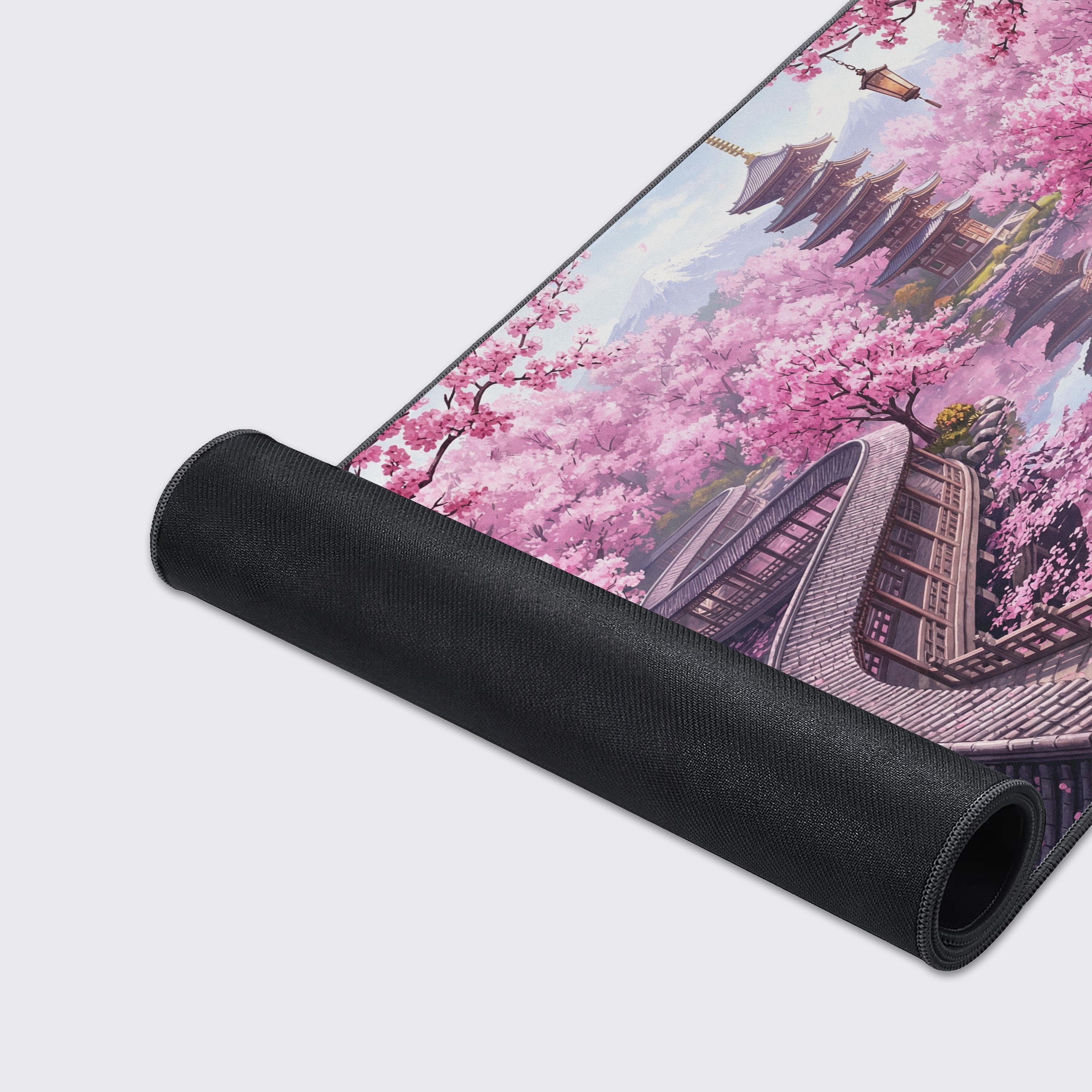 A close-up of the Tranquil Spring gaming desk mat, highlighting the durable stitched edges and smooth fabric texture of the Japanese garden and sakura blossom design. - Epic Design Pads & Mousepads