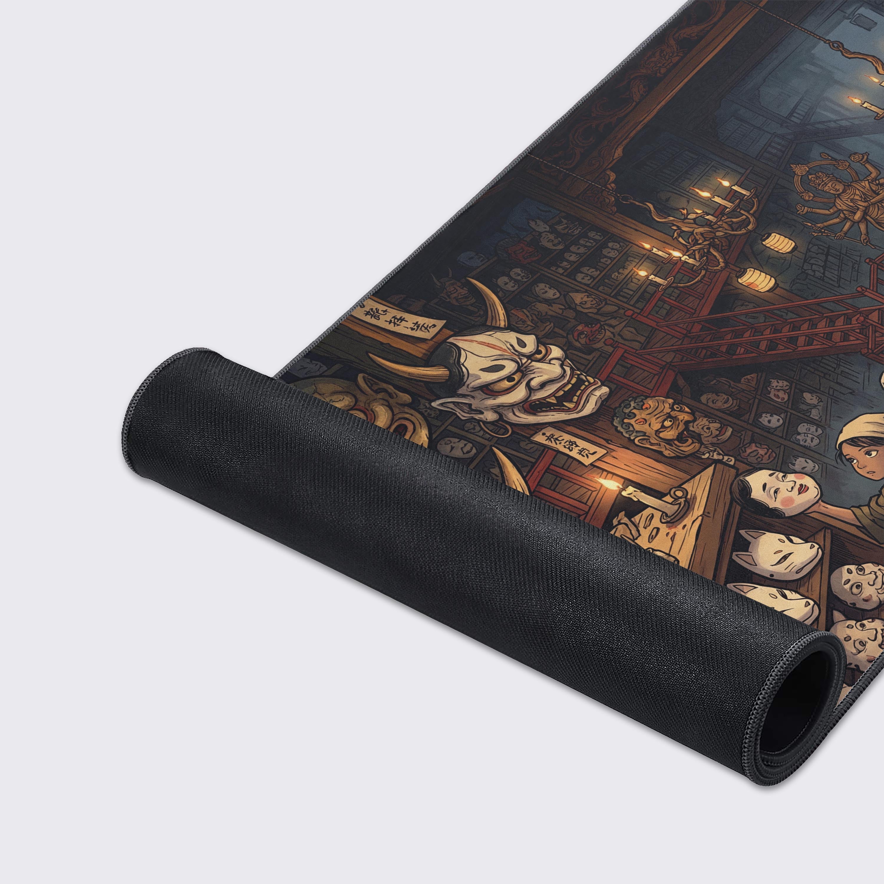 A close-up of the Yokai Mask Maker gaming desk mat, highlighting its non-slip rubber base, stitched edges, and vibrant artwork of a Japanese artisan's workshop. - Epic Design Pads & Mousepads