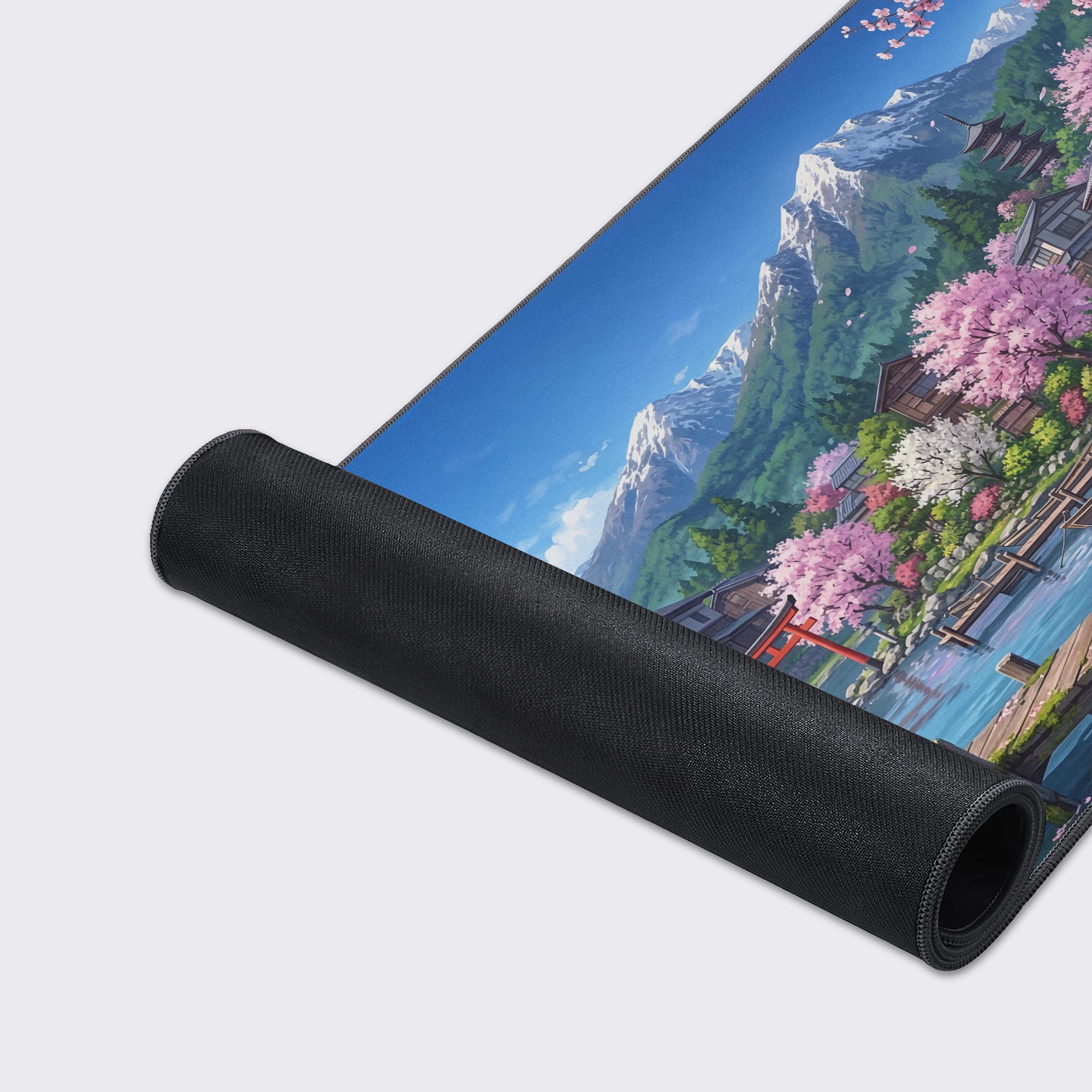 Close-up of the Sakura Shores gaming desk mat, highlighting the smooth fabric texture and durable stitched edges against the detailed anime-style village artwork. - Epic Design Pads & Mousepads