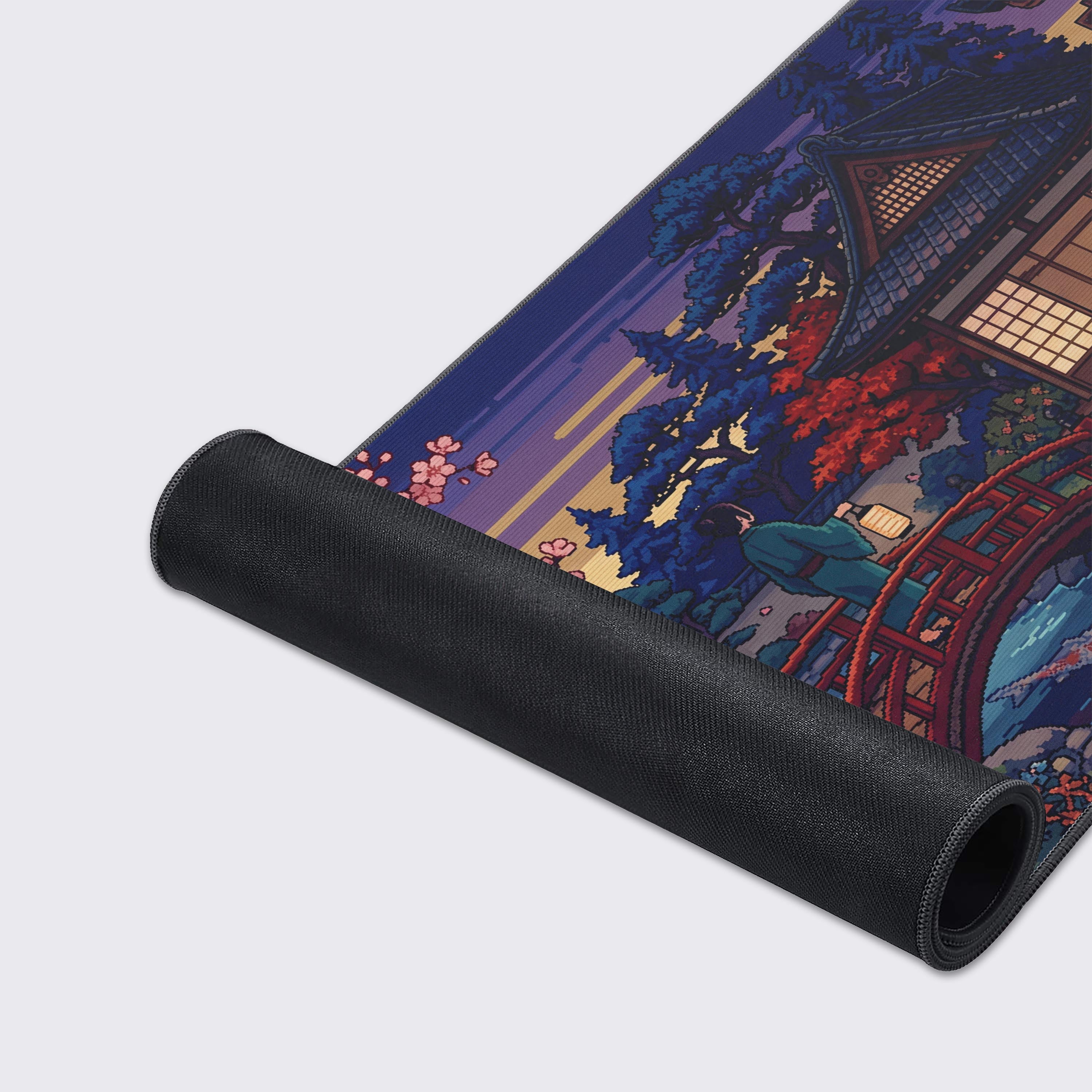 Close-up of the Retro Garden Gaming Desk Mat's smooth texture and durable stitched edges, highlighting the vibrant pixel art design of a Japanese koi pond and bridge. - Epic Design Pads & Mousepads