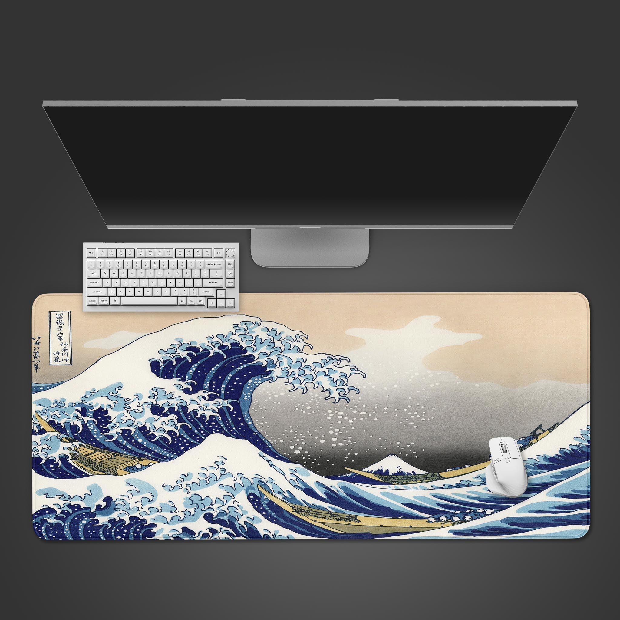 The Great Wave desk mat by Hokusai shown from above. The large Japanese art mouse pad has a keyboard and mouse on top, displaying its ample size.