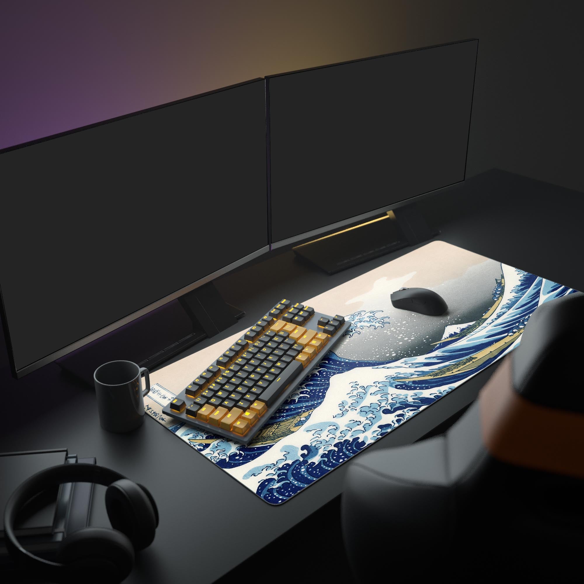 Aesthetic desk setup featuring The Great Wave desk mat. The Hokusai mouse pad is shown with a mechanical keyboard, dual monitors, and headphones.