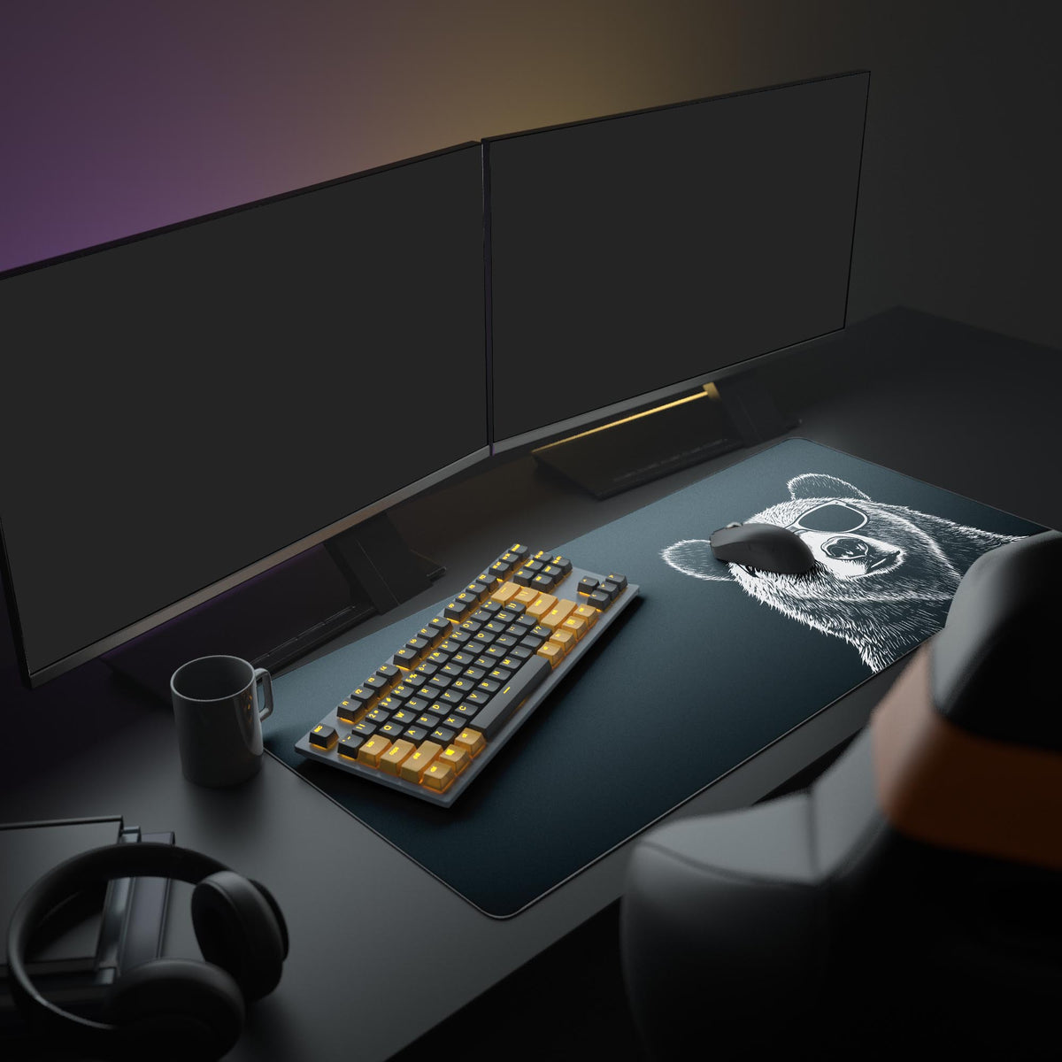 Grizzly Bear Desk Pad in a dark gaming setup with a mechanical keyboard, a mouse and headphones