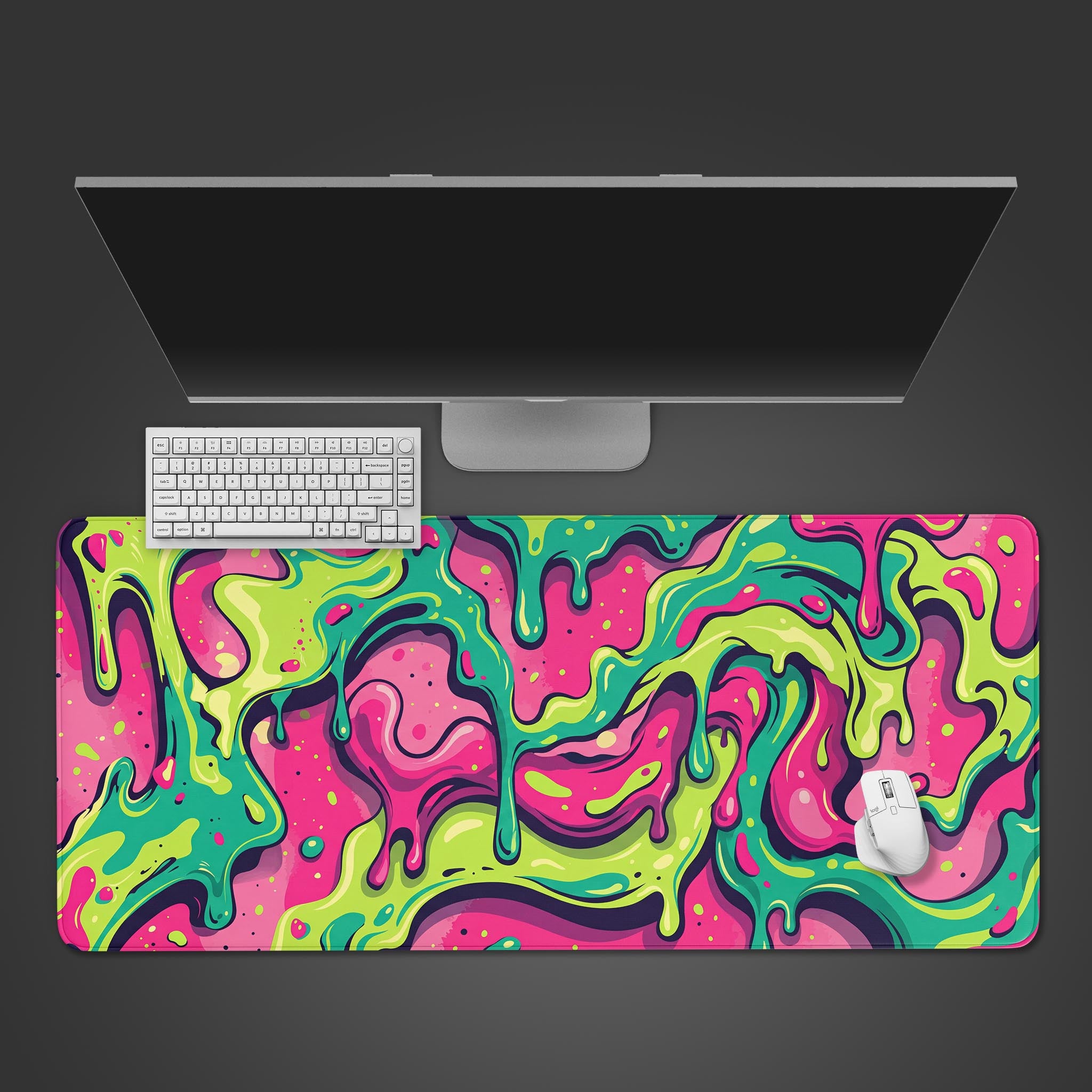 The Acid Drip gaming desk mat shown from above, featuring a vibrant pink and green abstract design under a white keyboard, mouse, and monitor. - Epic Design Pads & Mousepads