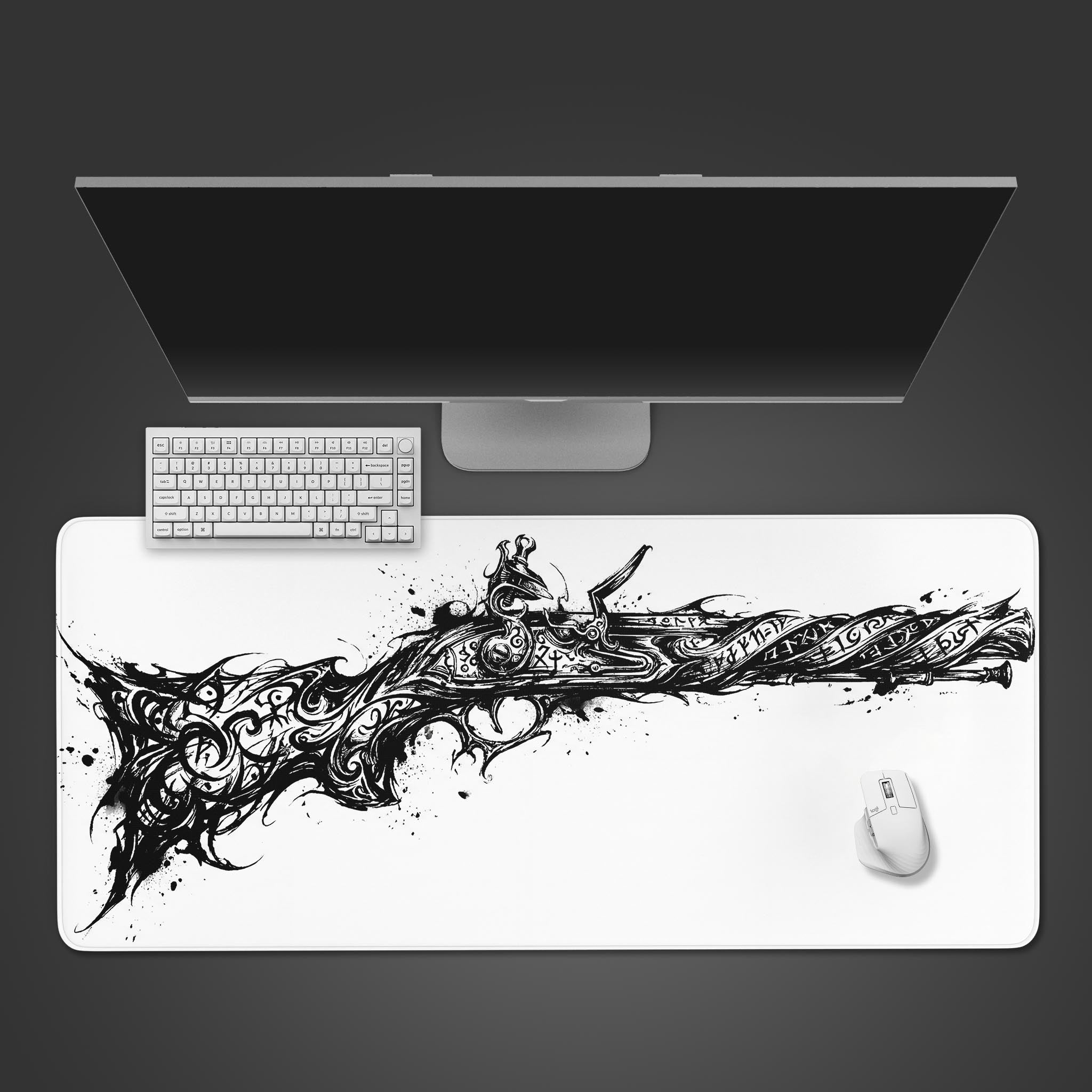 Top-down view of the Arcane Flintlock gaming desk mat, featuring a monochrome pistol design, with a white keyboard and mouse on a dark surface. - Epic Design Pads & Mousepads