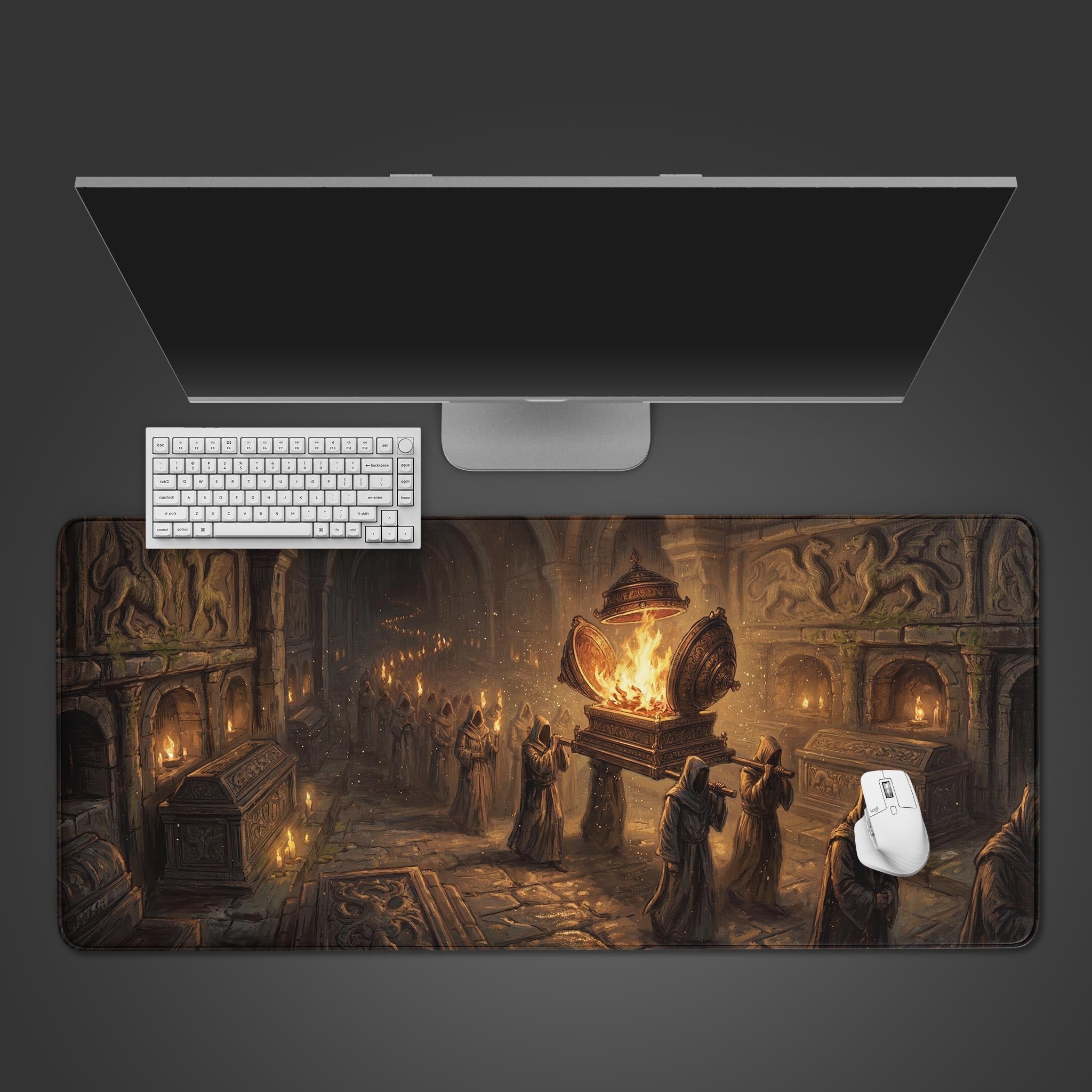 The Ashen Pilgrimage gaming desk mat displays a dark fantasy crypt procession, shown from above with a white keyboard and mouse. - Epic Design Pads & Mousepads