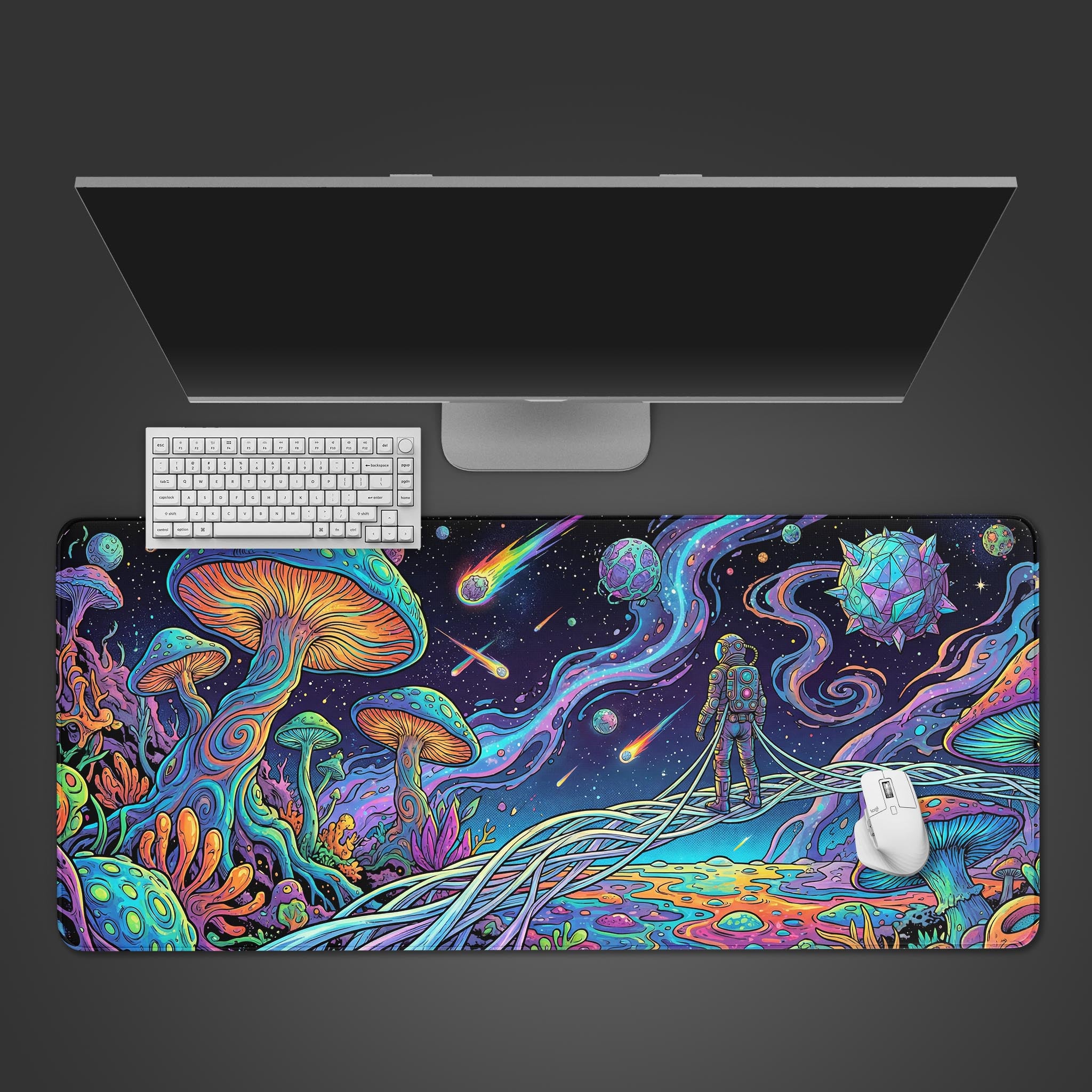 Top-down view of the Astral Mycelium gaming desk mat featuring a psychedelic astronaut and mushroom design, shown with a white keyboard, mouse, and monitor on a dark background. - Epic Design Pads & Mousepads