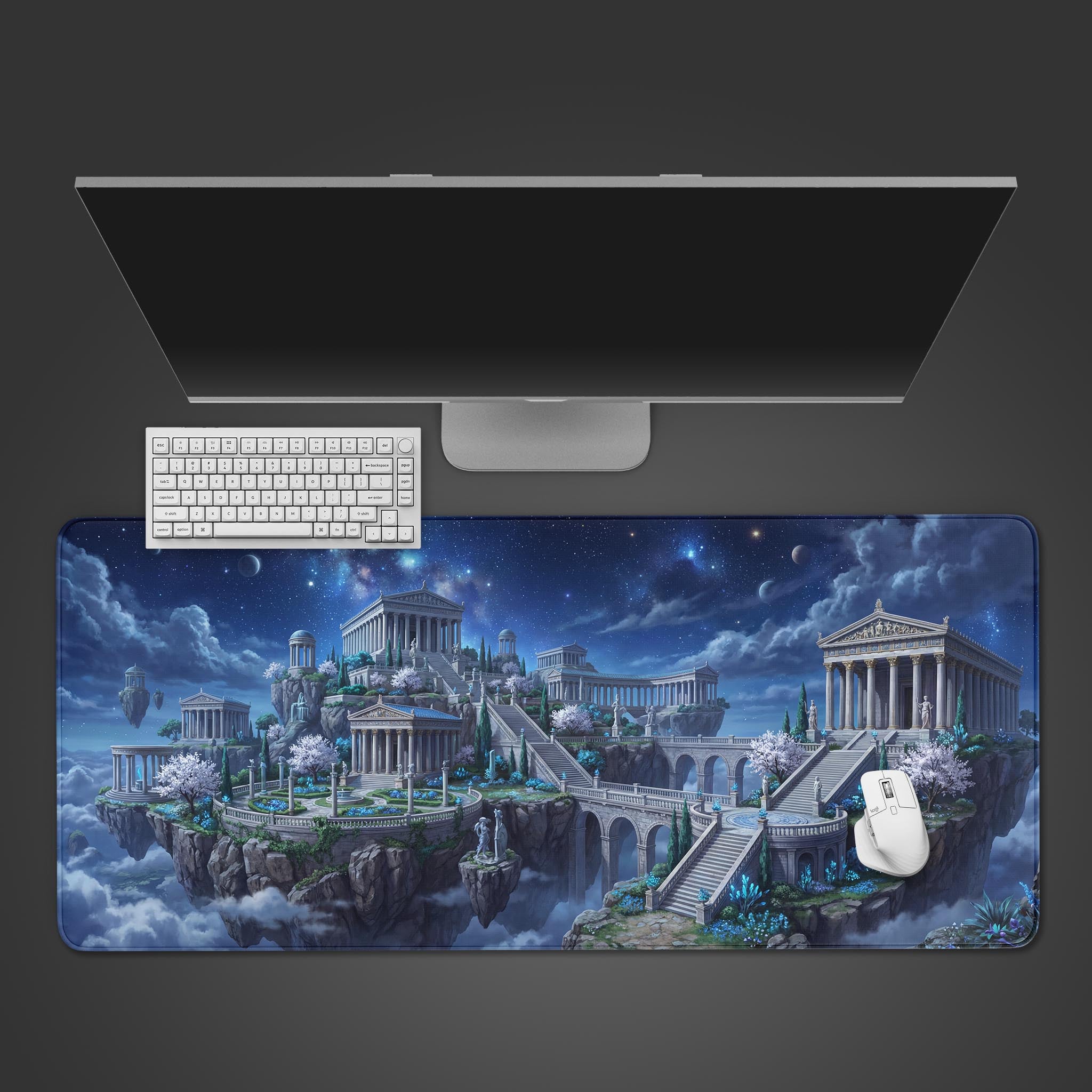 Top-down view of the Astral Pantheon gaming desk mat featuring floating Greek temples under a starry sky, shown with a white keyboard and monitor on a dark background. - Epic Design Pads & Mousepads