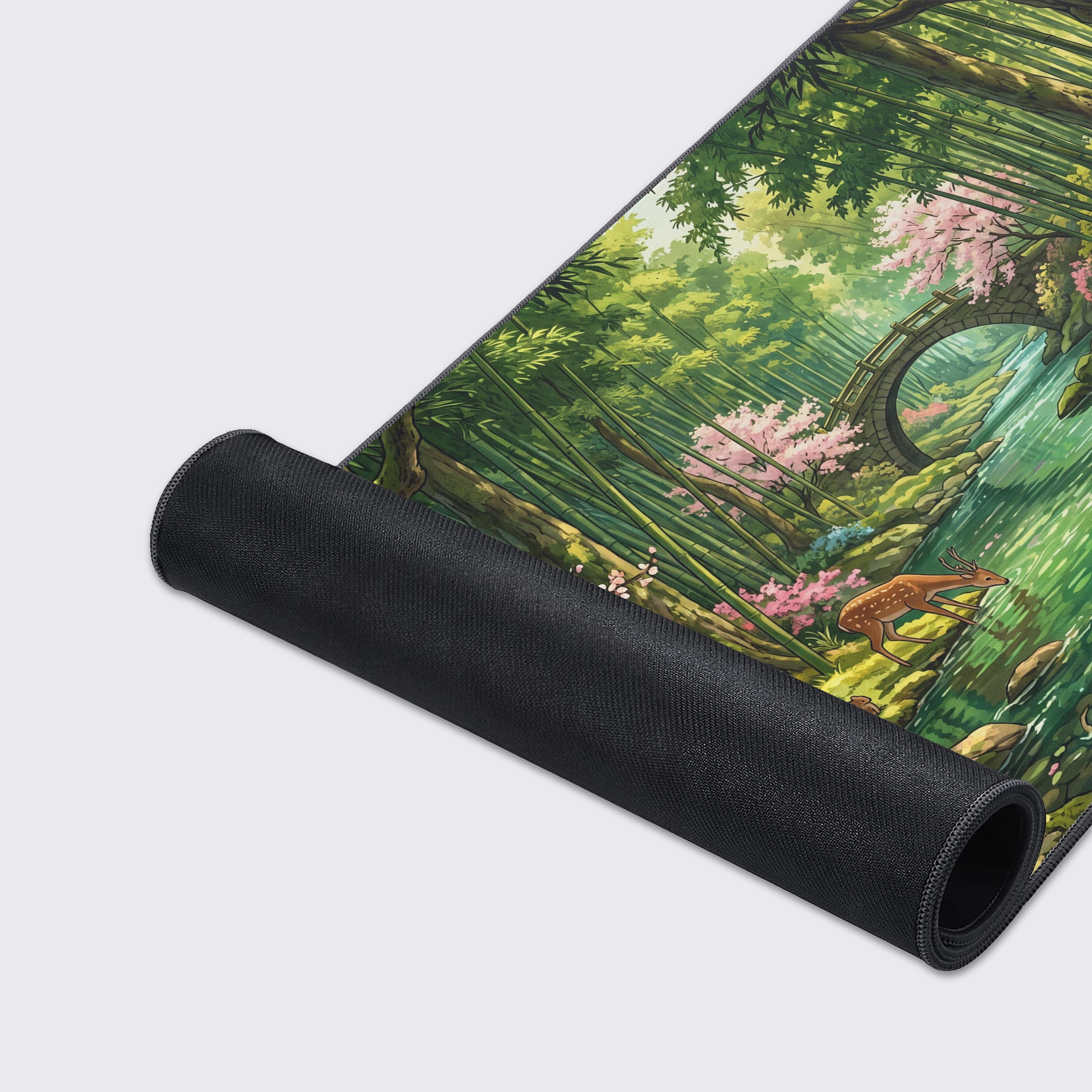 Extended gaming mouse pad highlighting a peaceful woodland scene with a clear stream and pink blossoms.